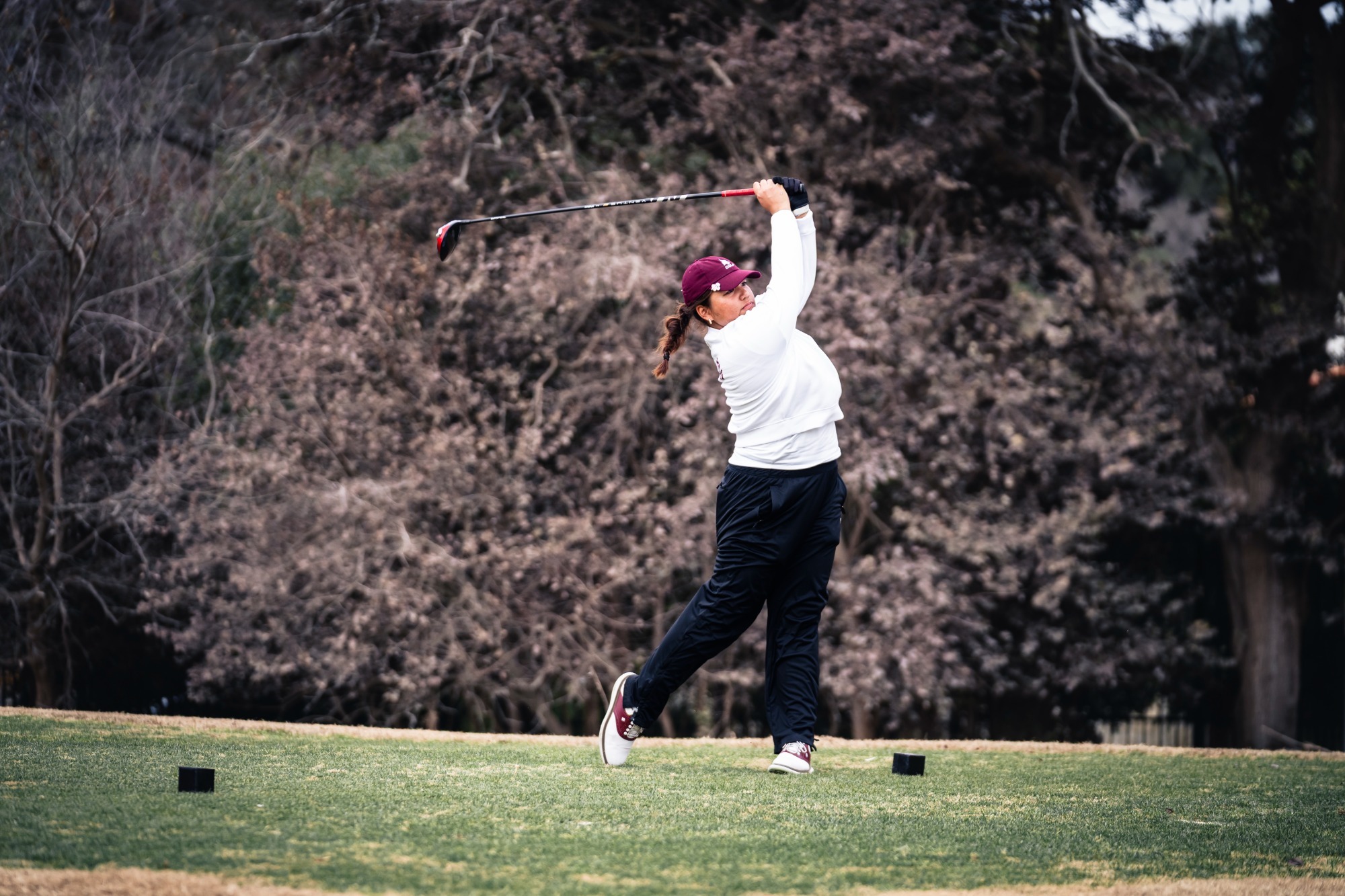 Golfer Grace Quintanilla swinging a club at the 2026 Texas State Invitational