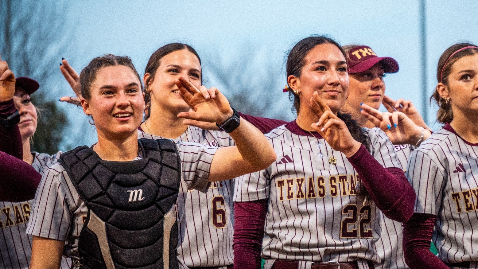 Maddy Azua and Megan Kelnar during alma mater after TXST won vs Texas A&M