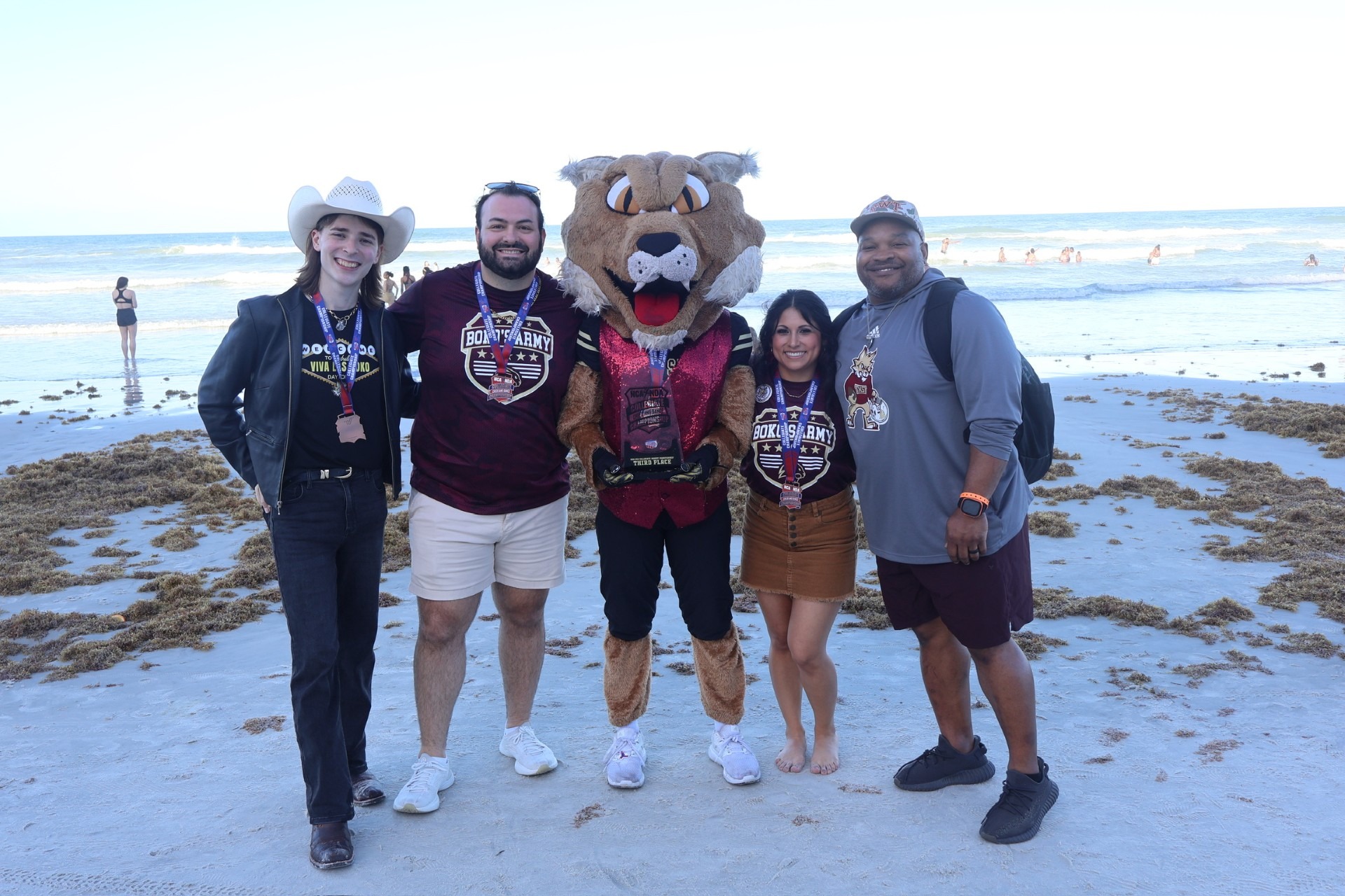 Boko and coaches pose on the beach after a third place finish at NCA Nationals