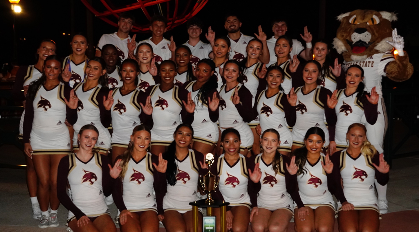 Texas State Spirit Program Poses with Trophy at NCA College National Championship