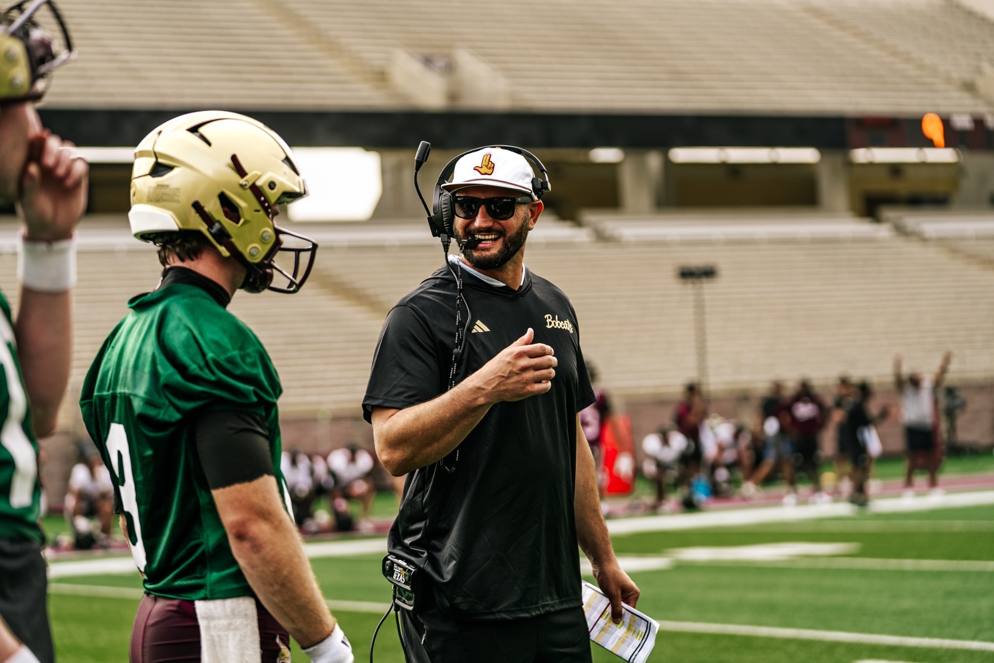 Head Coach GJ Kinne celebrates with Brad Jackson during TXST football fall practice