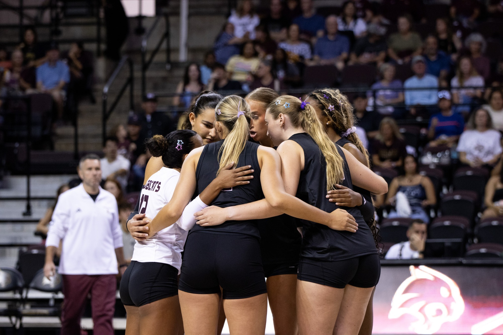 Team Huddle During Match Against Oklahoma