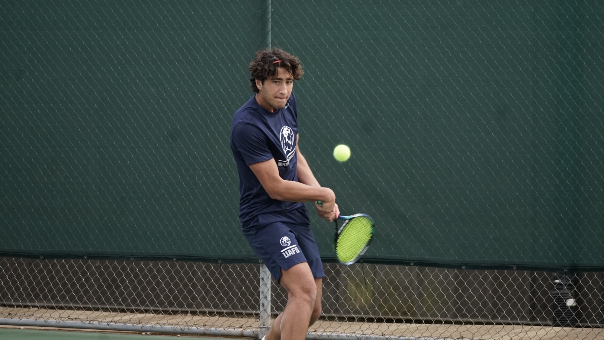 A UAFS tennis player returns a shot during a match. 