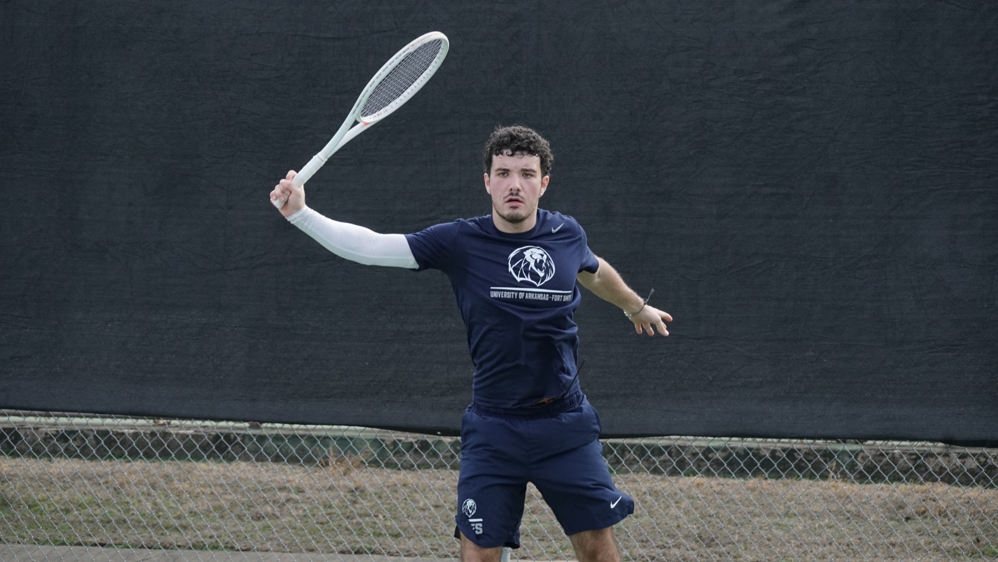 A UAFS tennis player returns a shot during a match. 