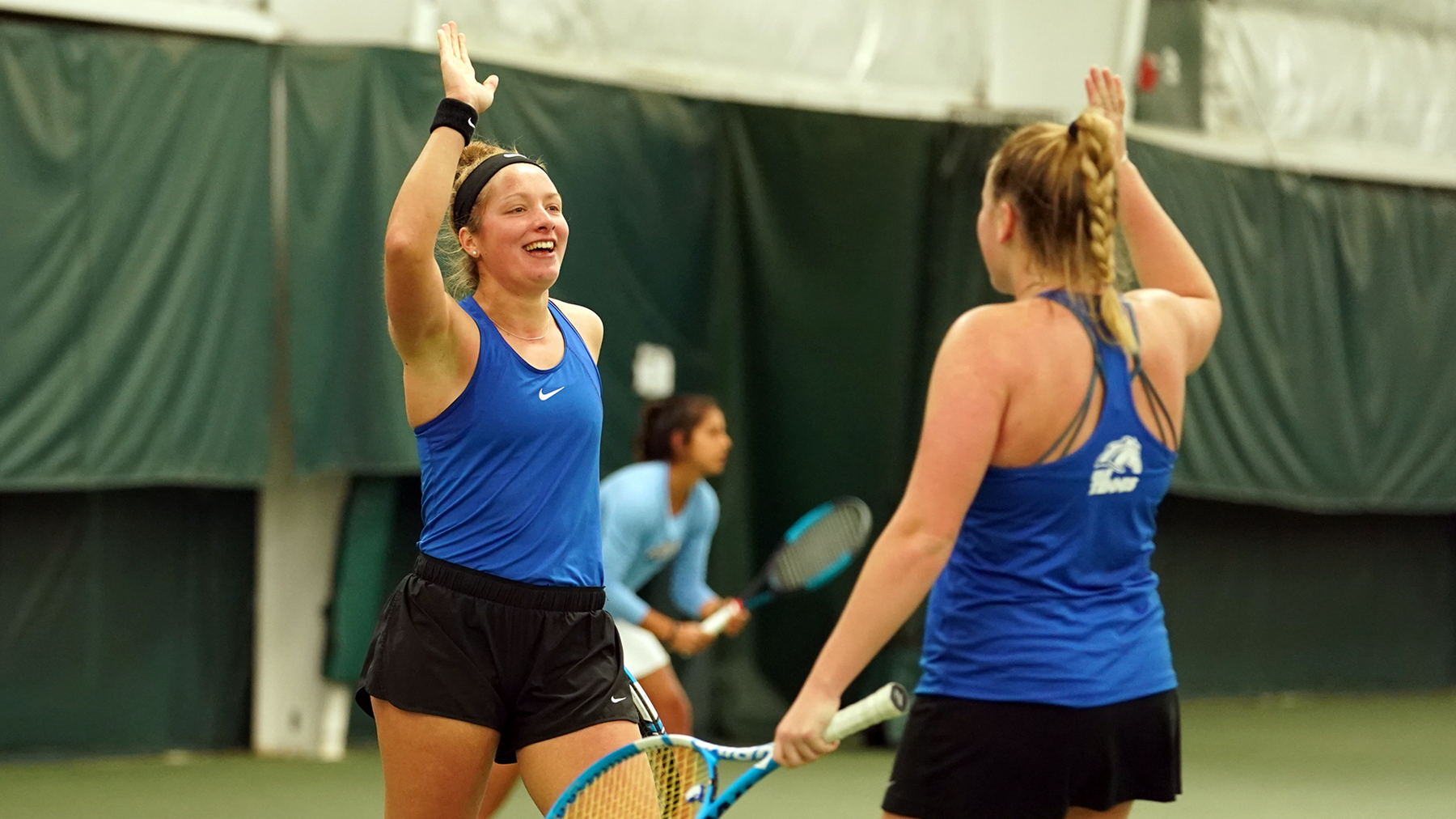 Stefanie Mehlich and Presley Thomas give each other five.