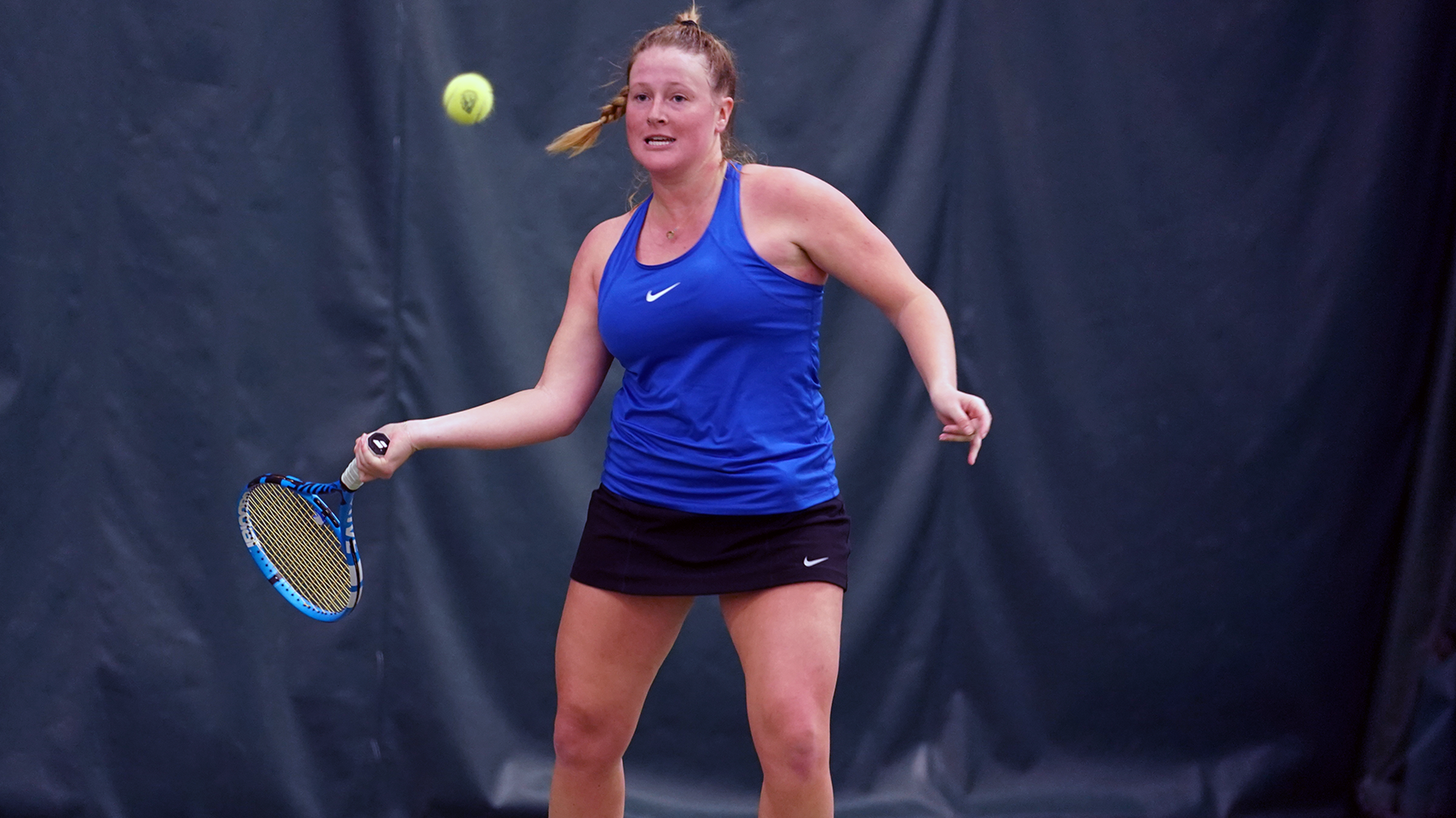 Presley thomas prepares to hit the tennis ball.