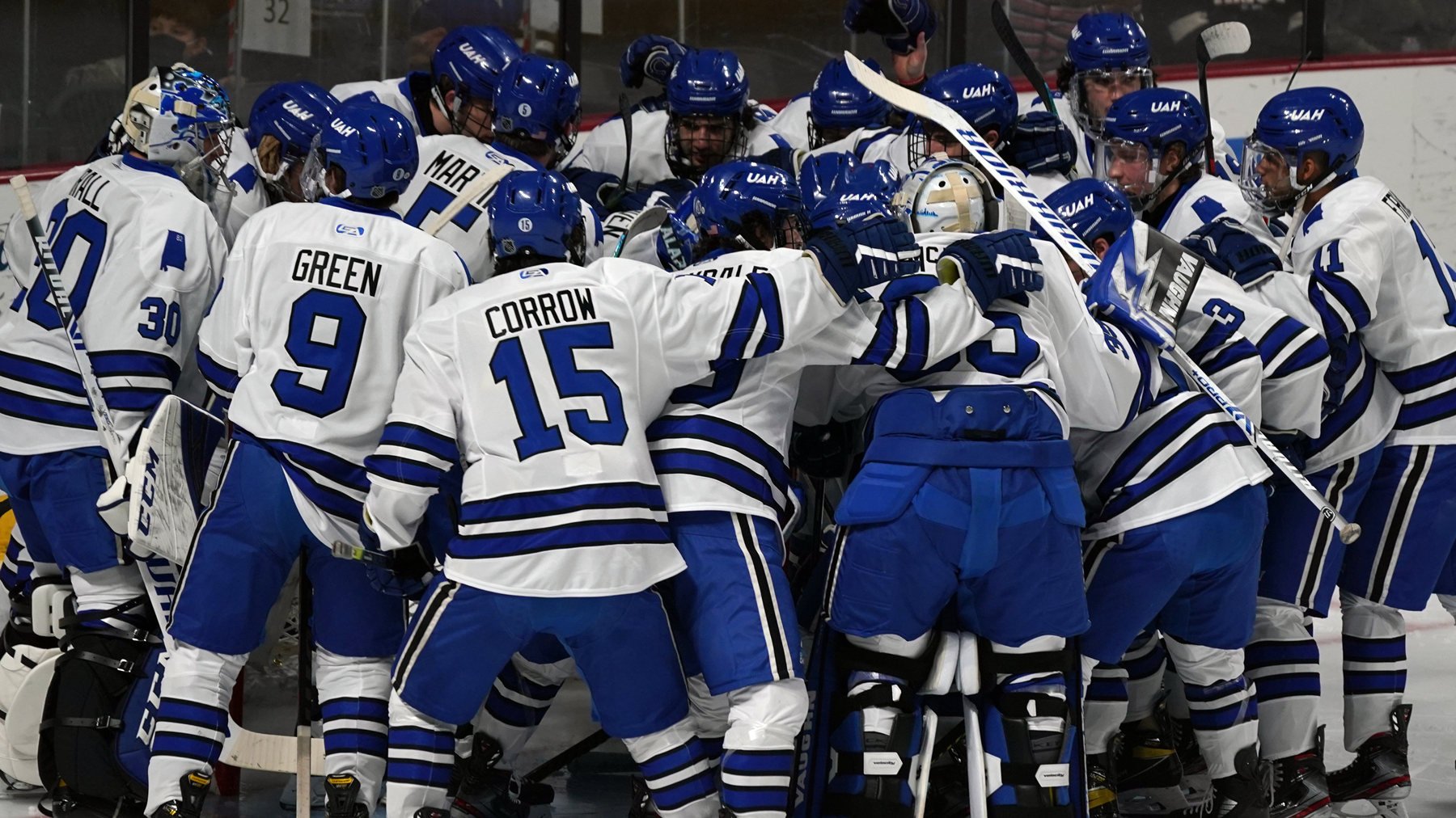 UAH hockey team huddles up around the goal before a game at the VBC
