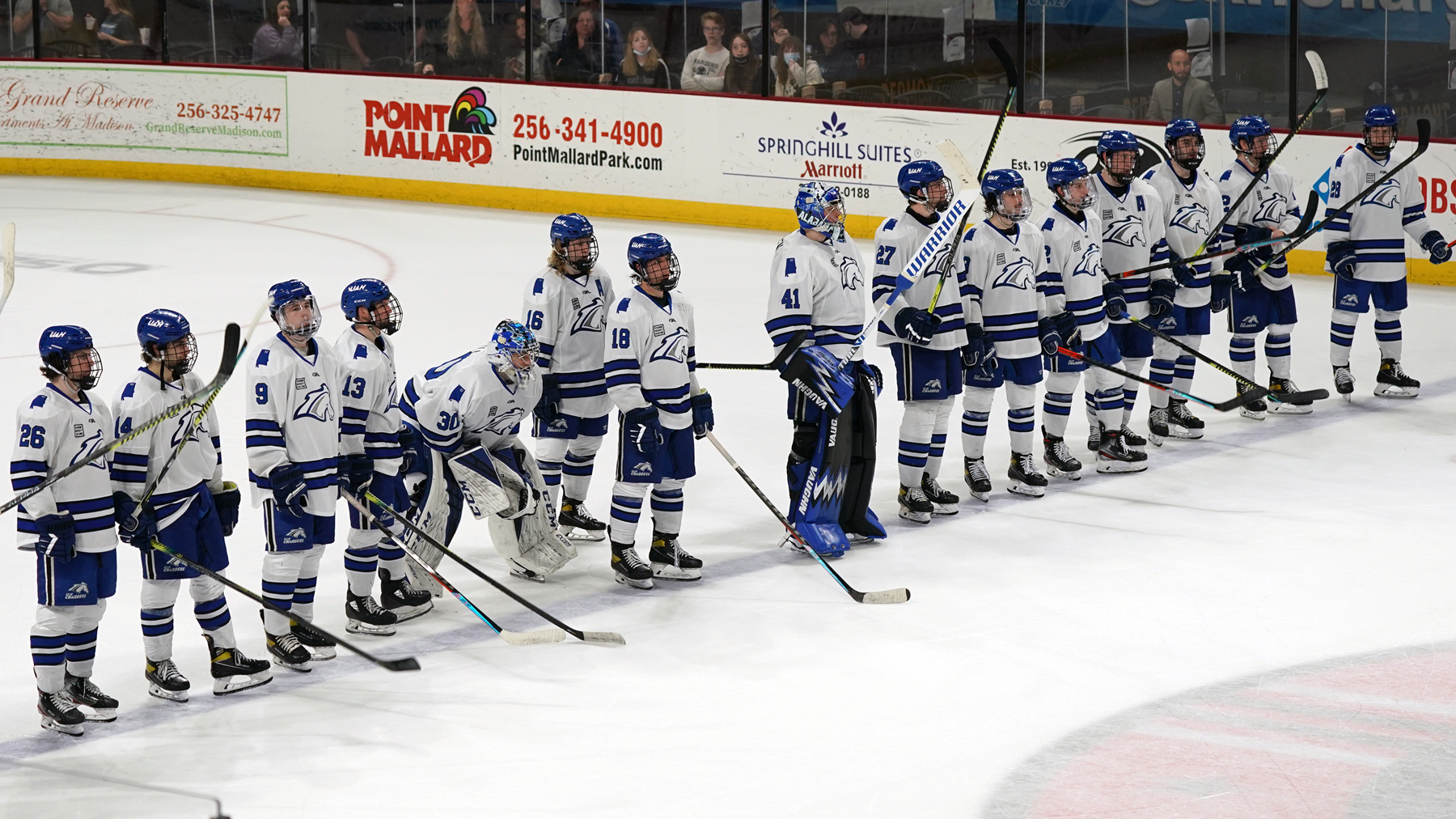 UAH hockey team after a game saluting their opponent at the blue line