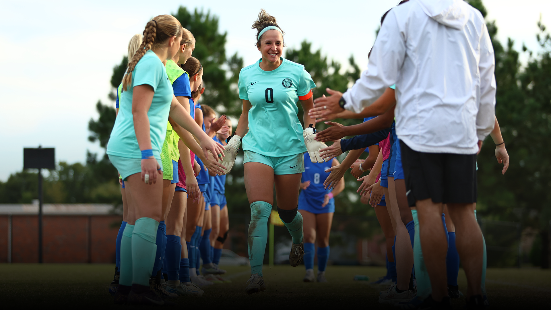 CeCe Szopa high fives her teammates as she takes the field