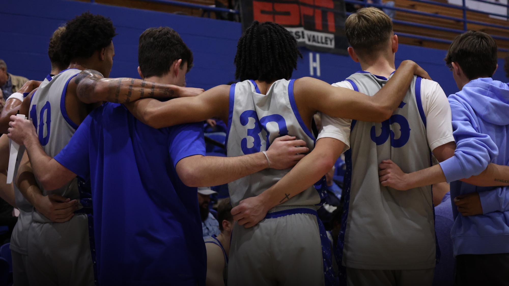 Basketball team huddled