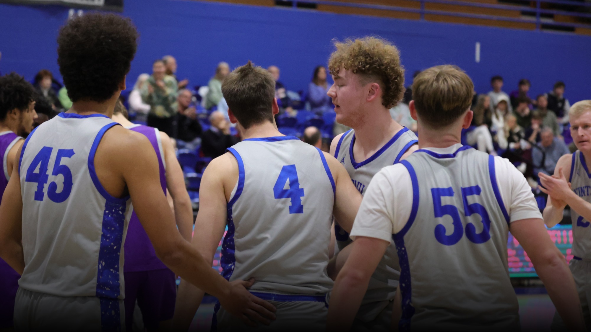 Basketball players celebrating a made shot