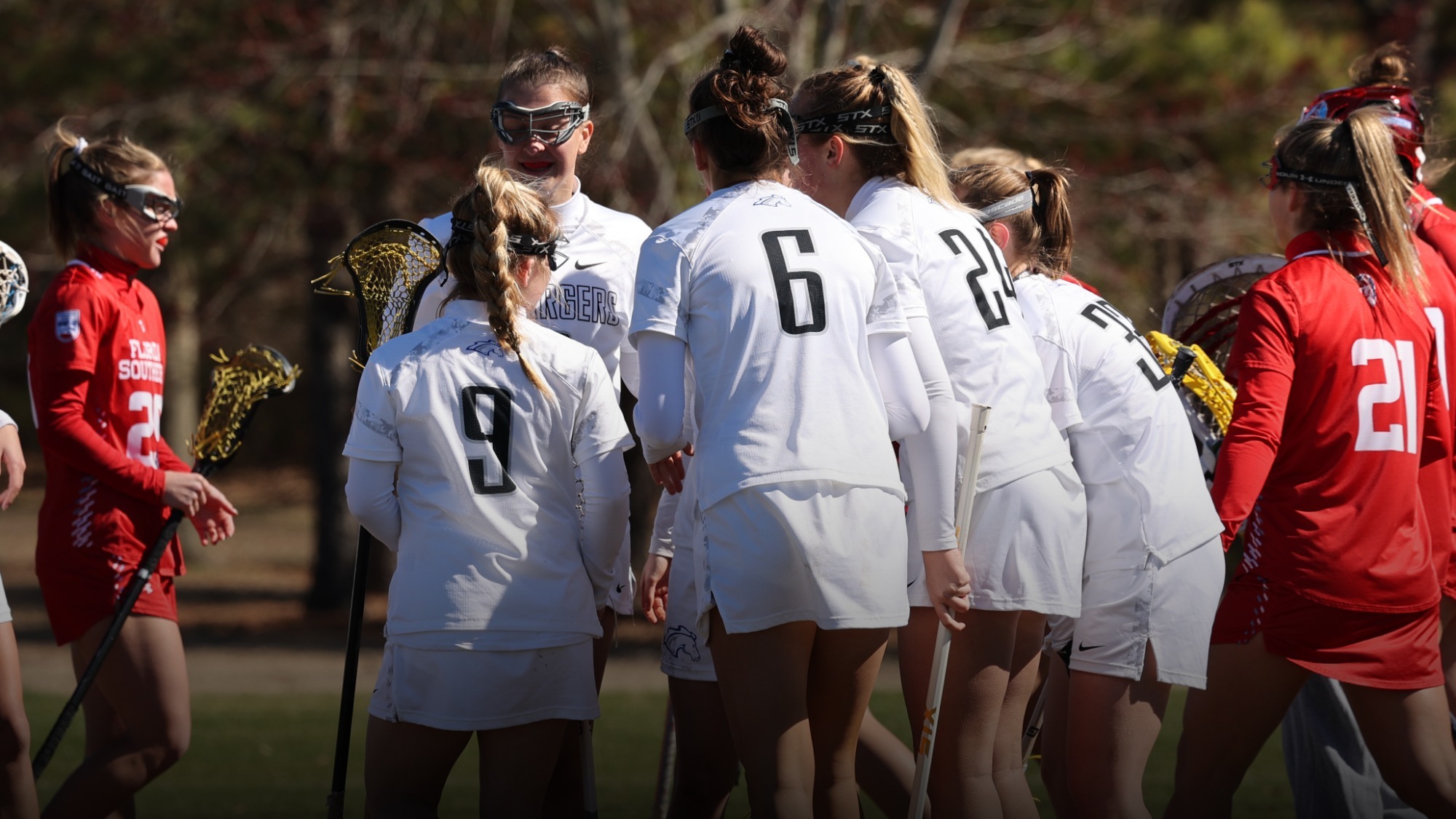 Women's lacrosse team huddled