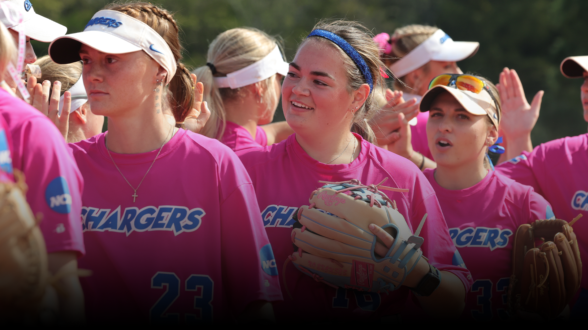 Katie Bracken high-fiving teammates between innings