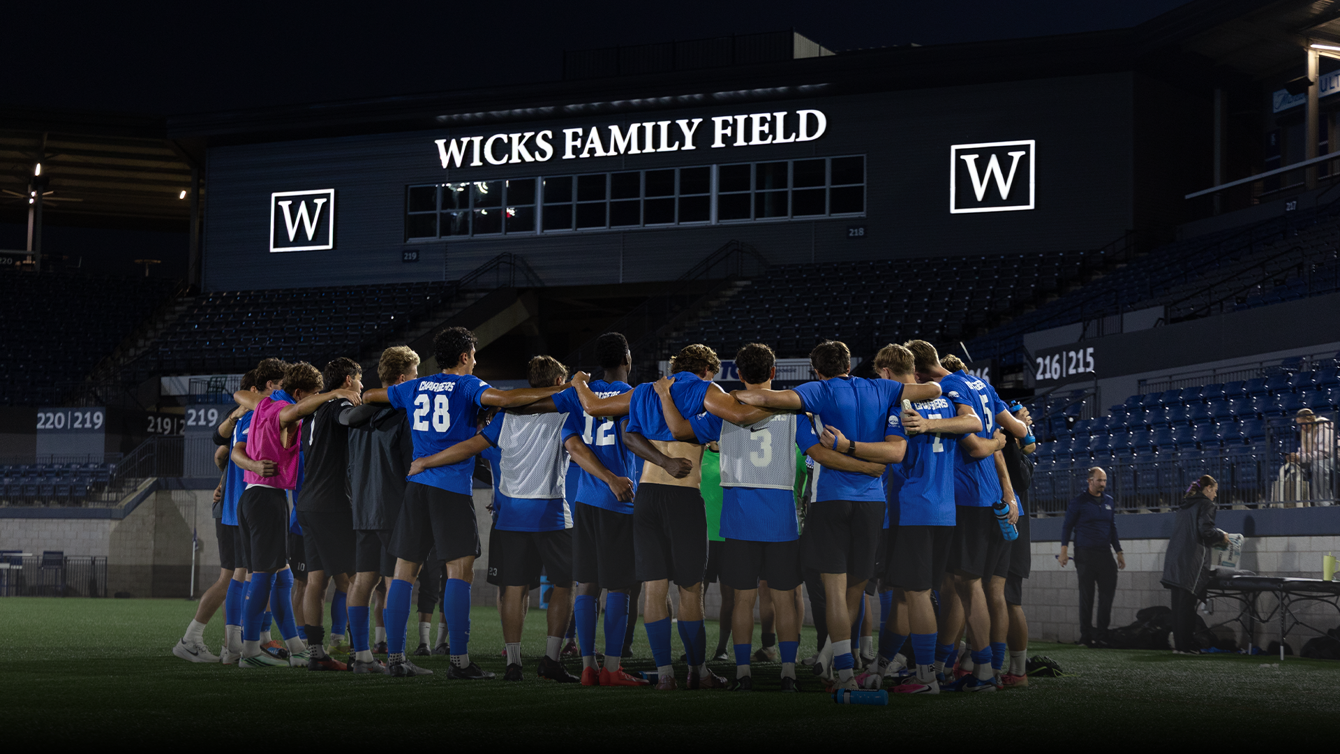 MSOC team huddled up at Wicks Family Field at Joe Davis Stadium