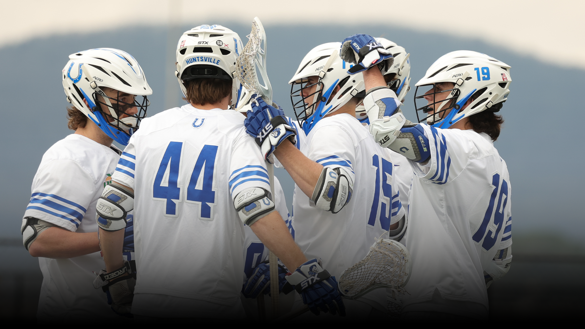 Men's Lacrosse team celebrating a goal