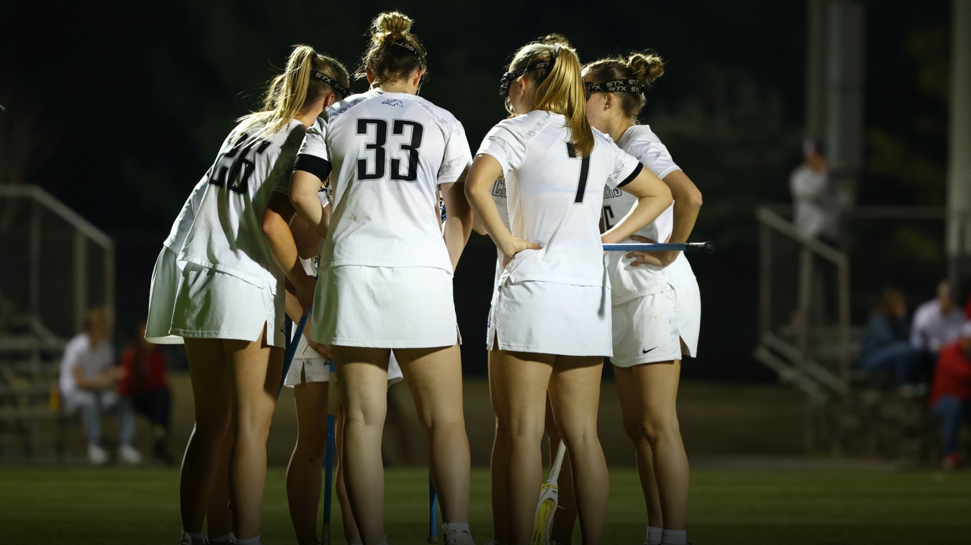 Women's lacrosse team huddled