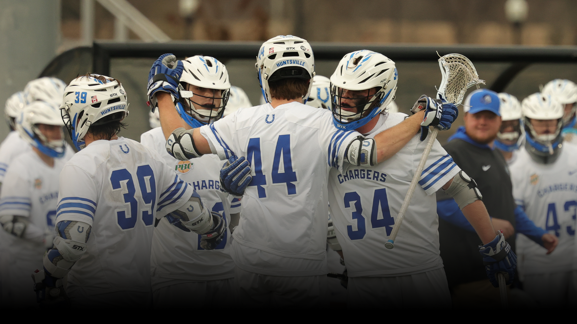 Men's Lacrosse team celebrating a goal together