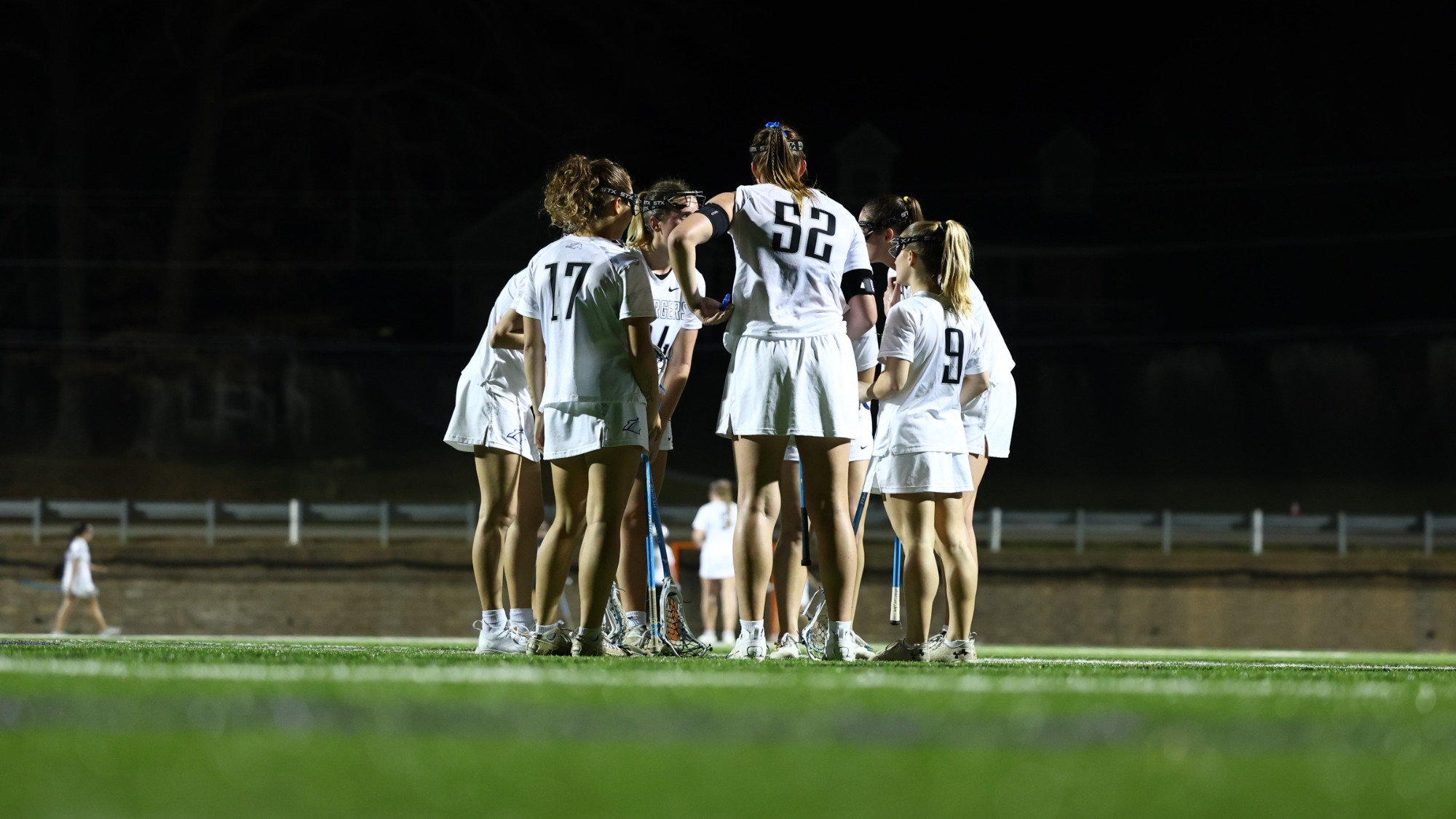 Women's lacrosse team huddled