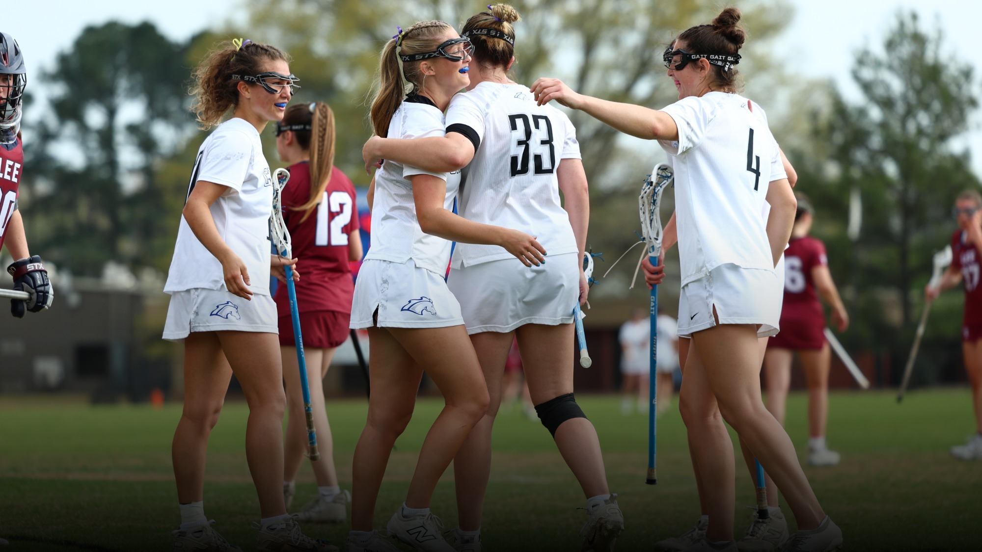 UAH women's lacrosse team celebrating a goal