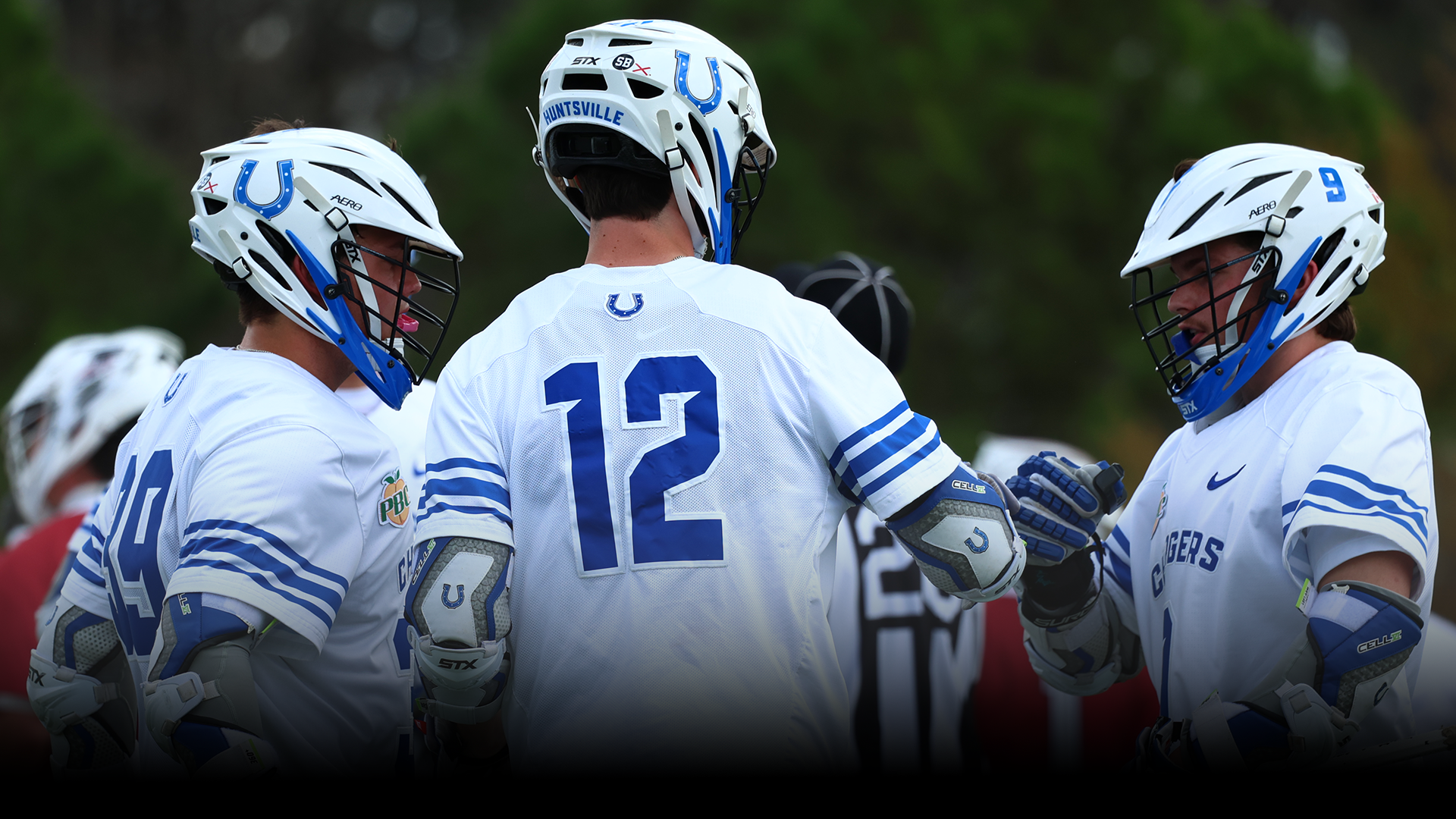 Men's Lacrosse team huddled up after a goal