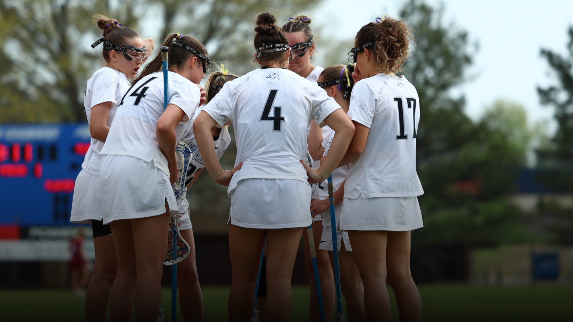 Women's lacrosse team huddled