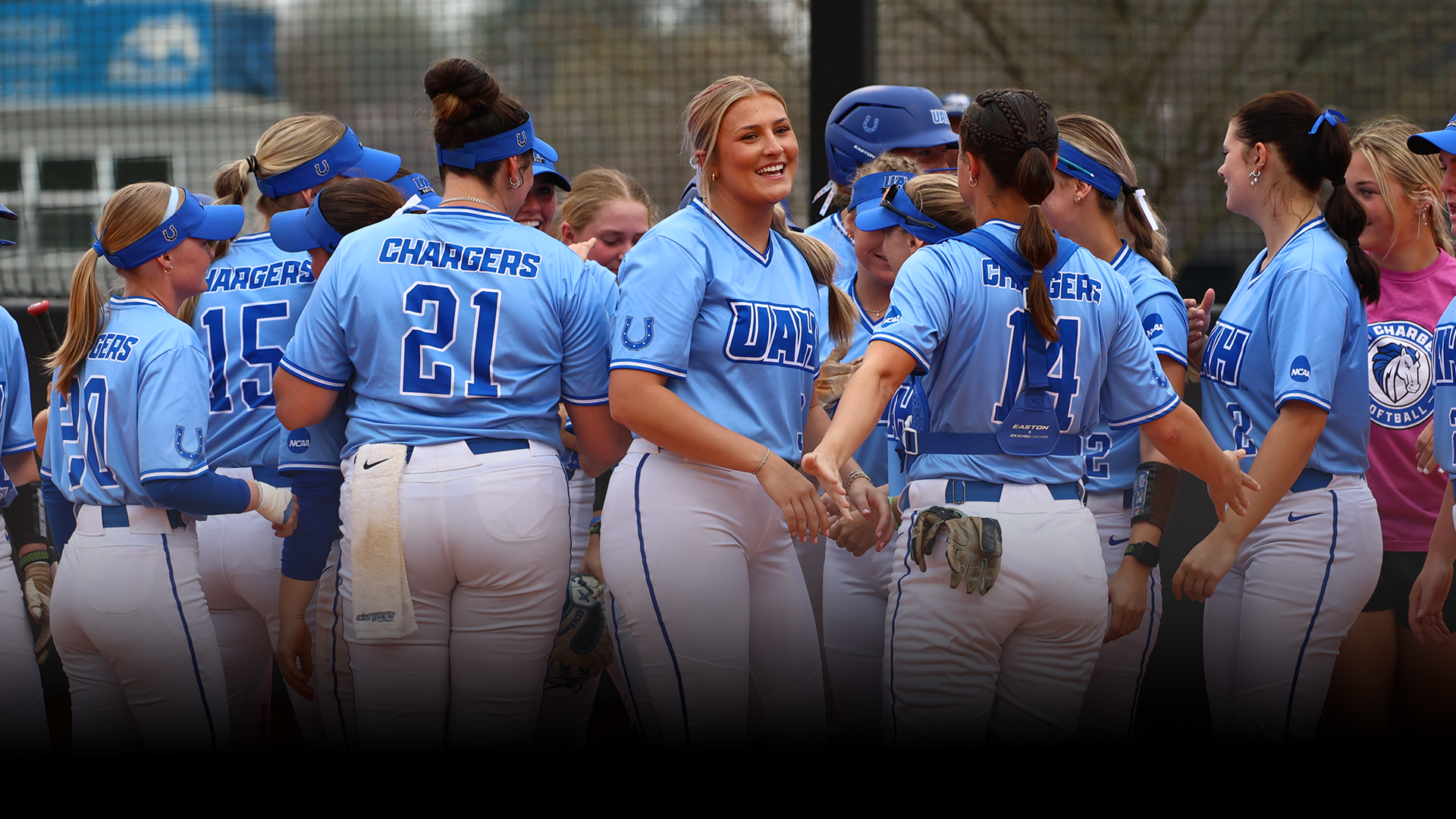 Kennah Lacy smiling after her teammate hits a home run