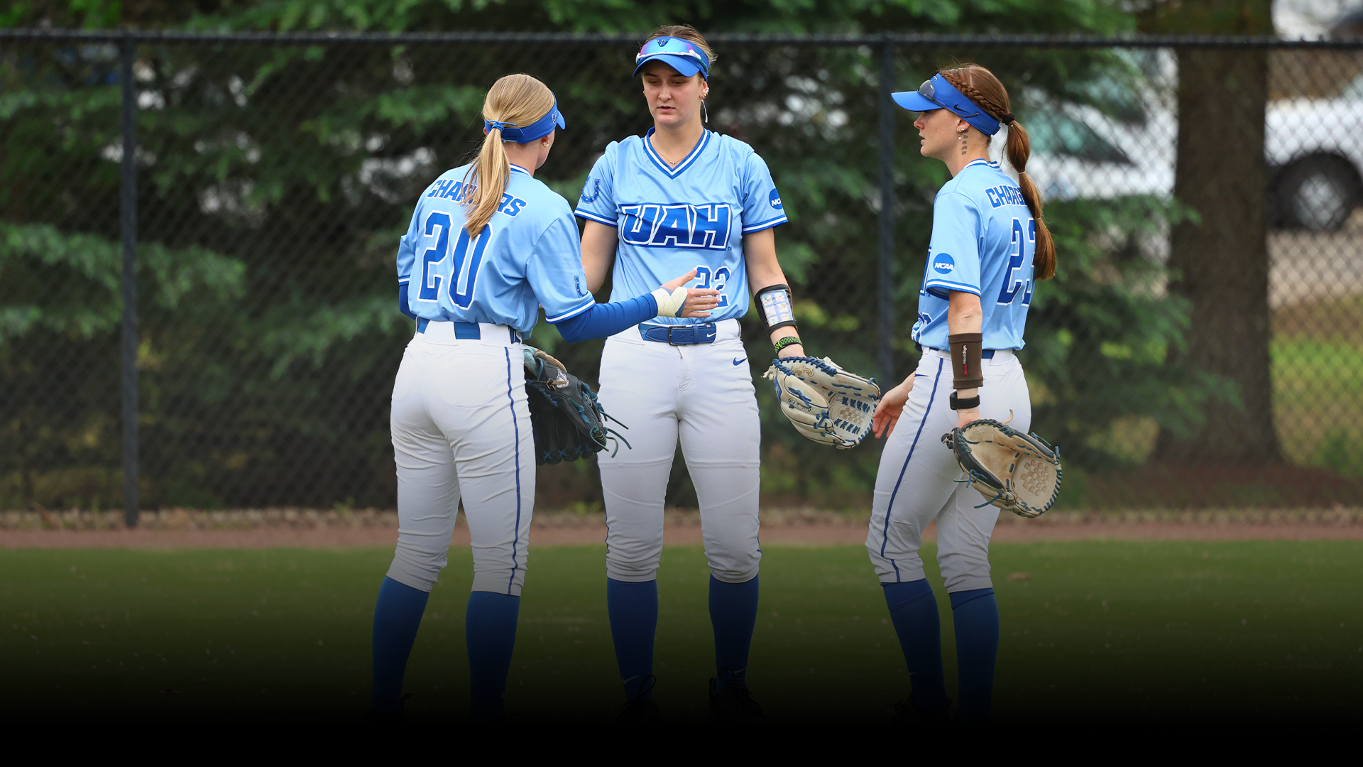 Softball outfield high-fiving 