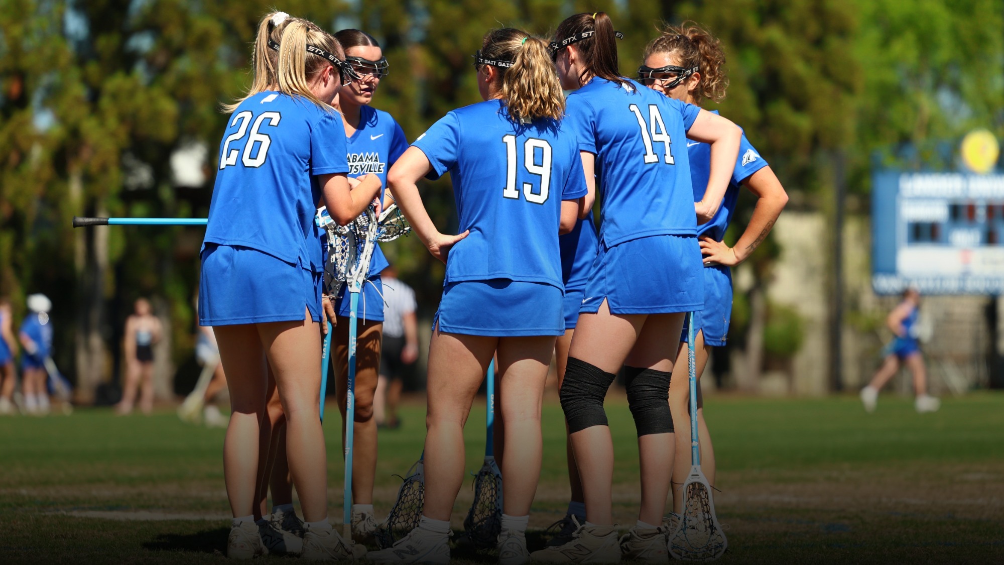 UAH Women's lacrosse players huddled