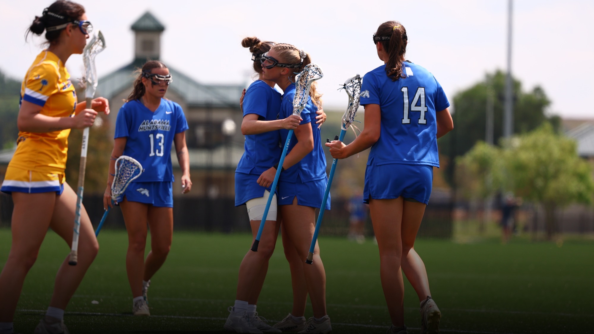 UAH Women's lacrosse players celebrating a goal