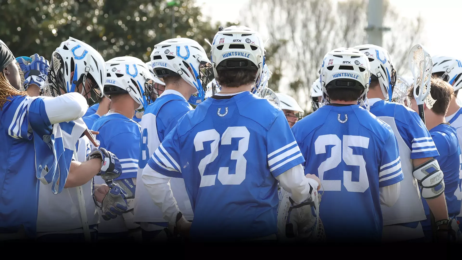 MLAX team huddled up prior to faceoff