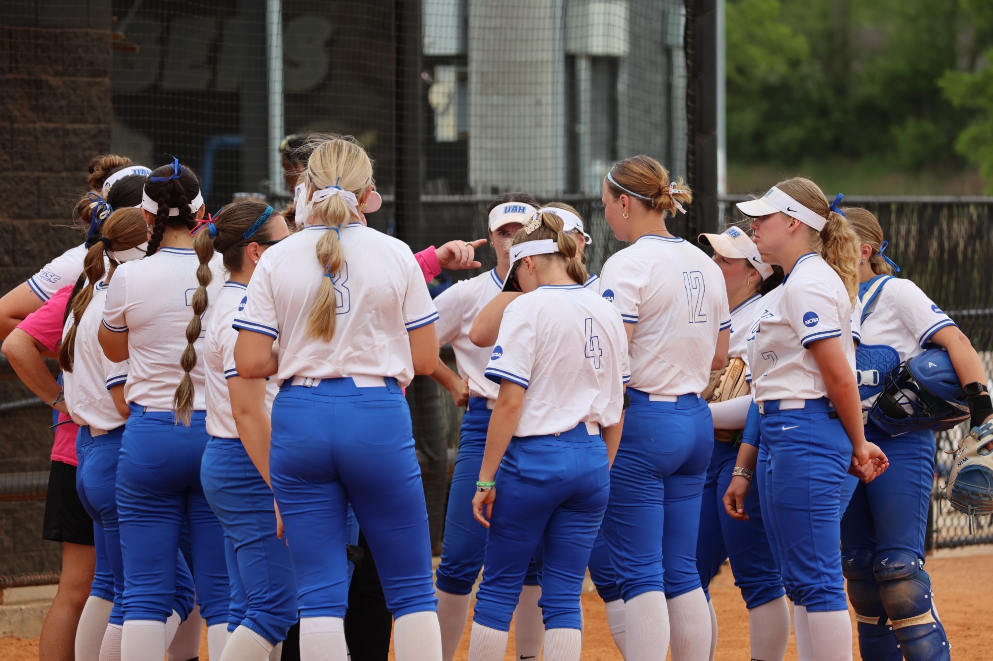 UAH softball team huddled