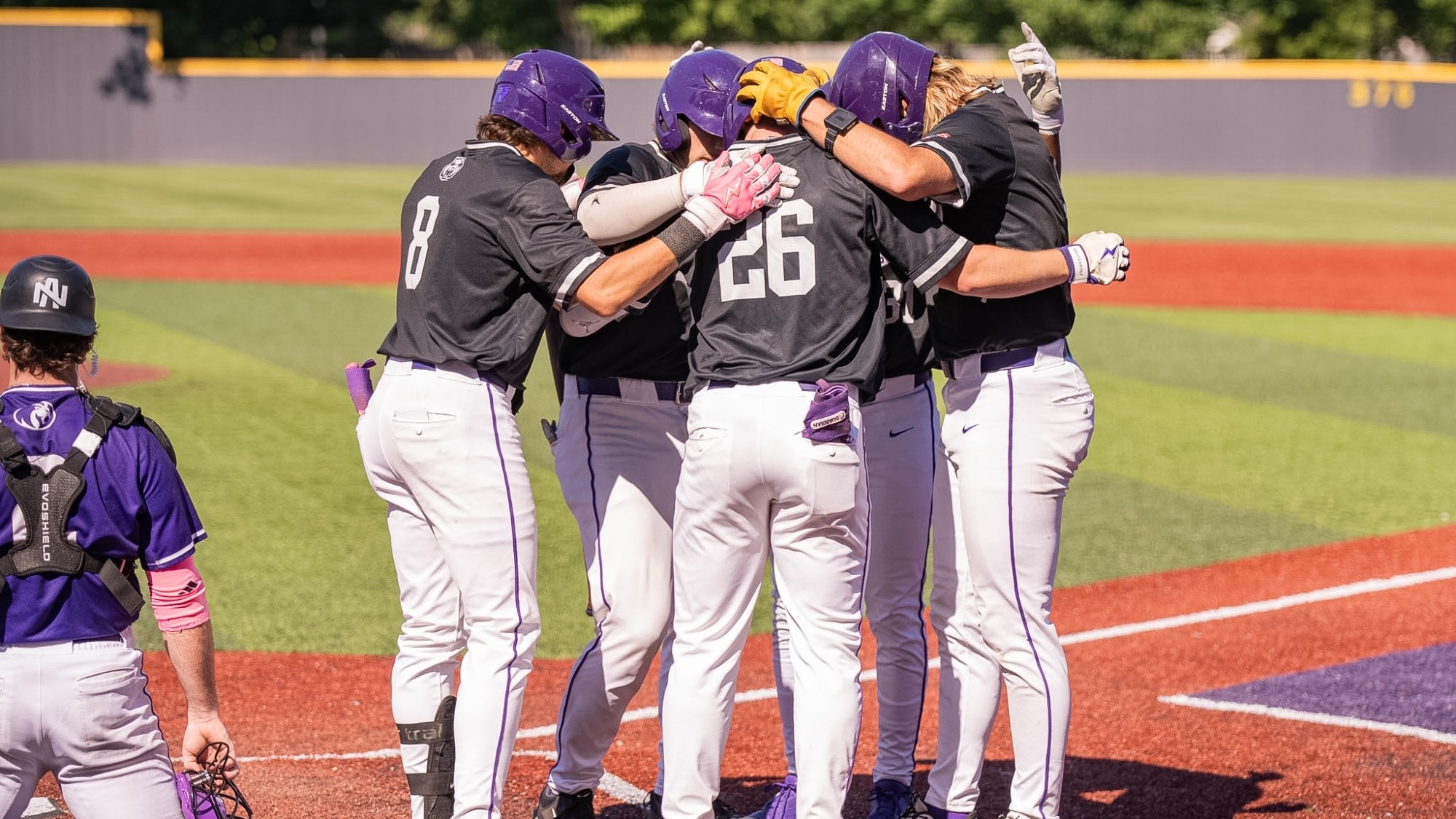 Gwyn and teammates at the plate
