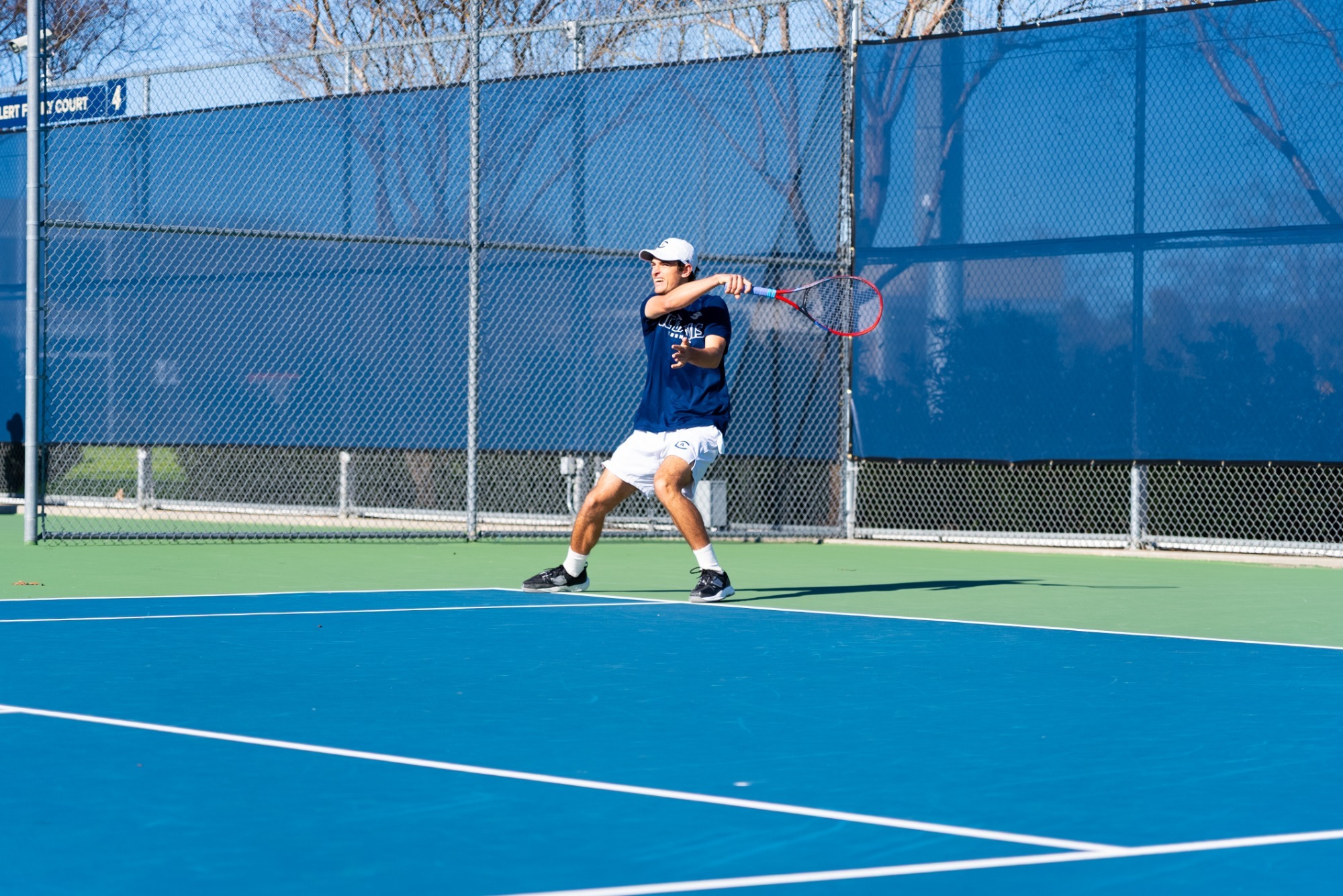 Men's tennis player returning a forehand