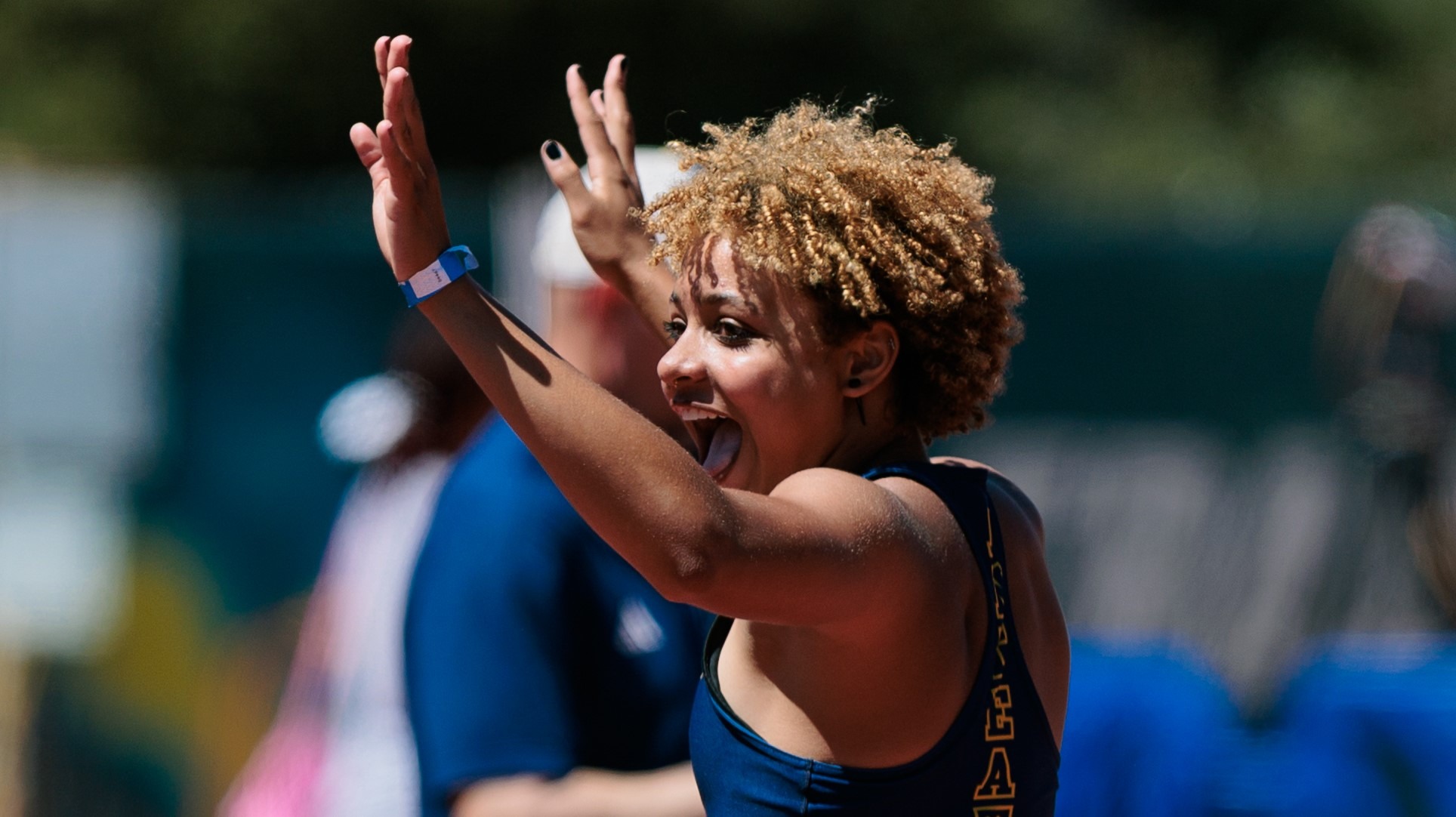Joy Anderson with arms raised in celebration