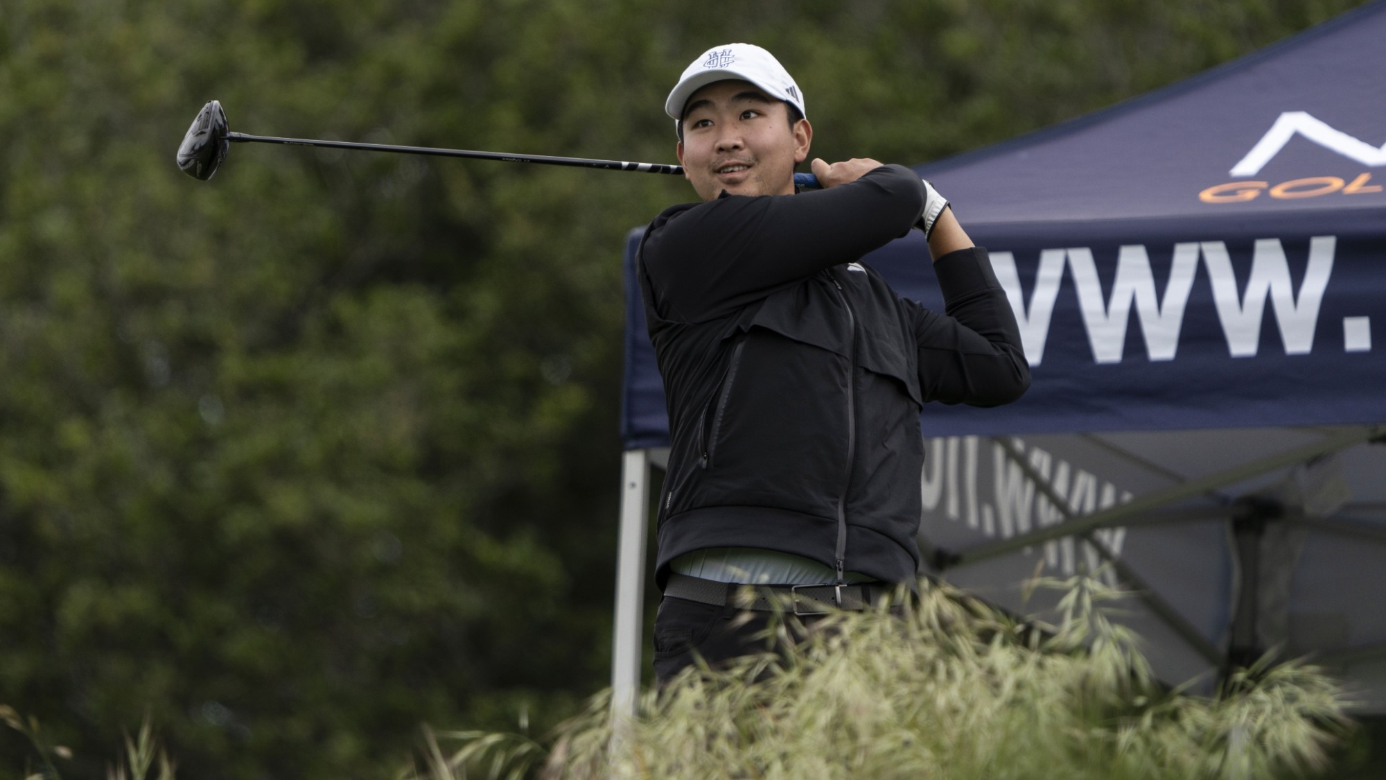 Jason Tang completes a golf swing