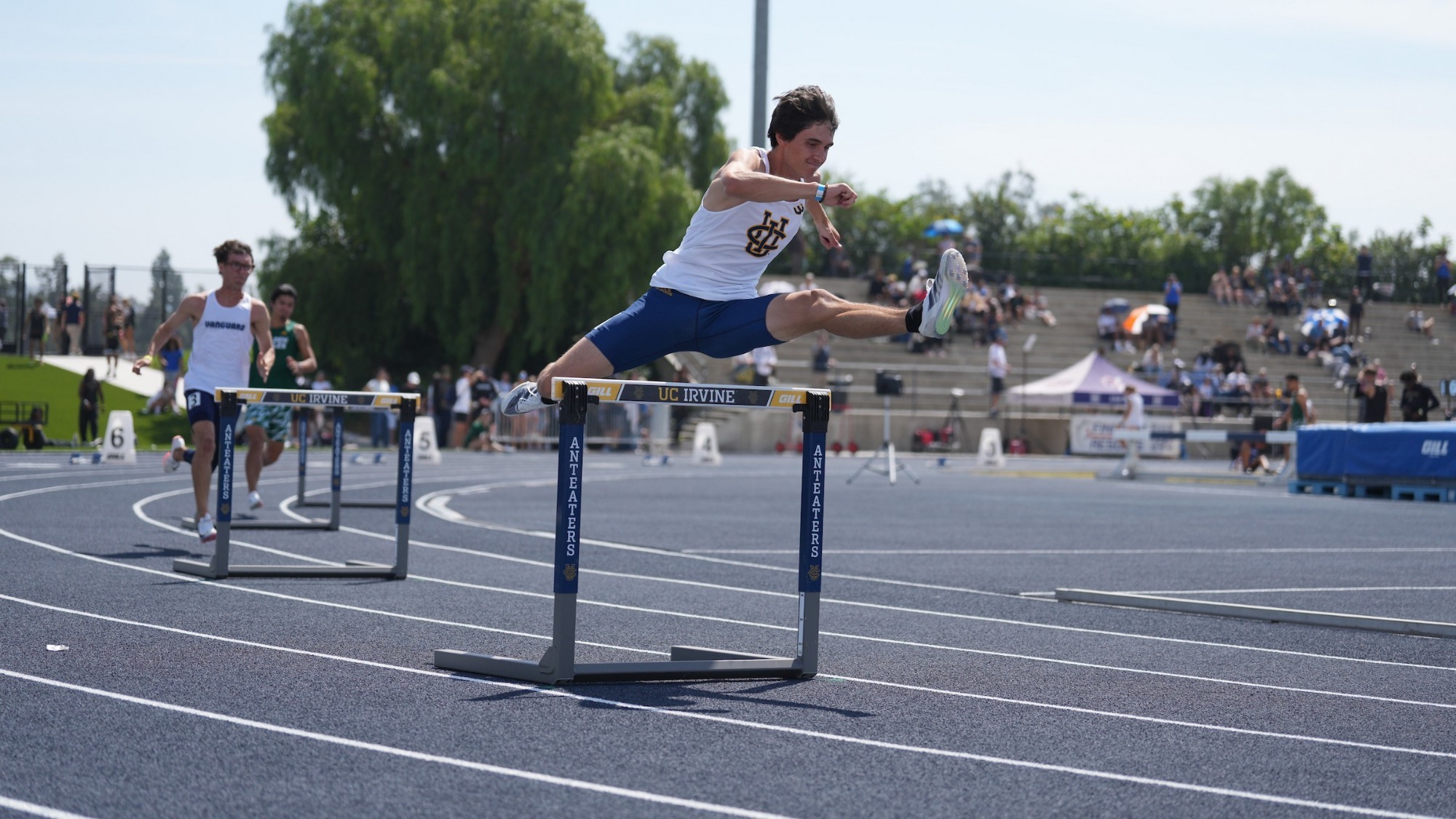Roman Mendoza leaps over a hurdles