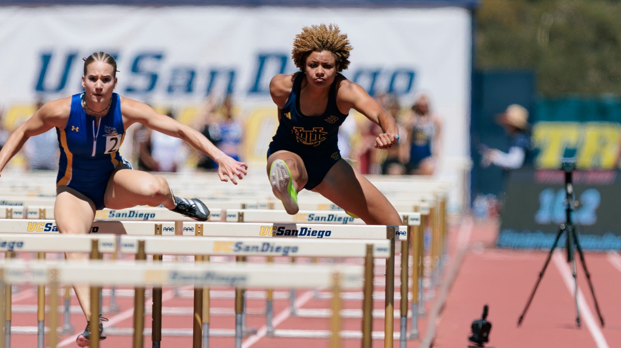 Joy Anderson going over a hurdle