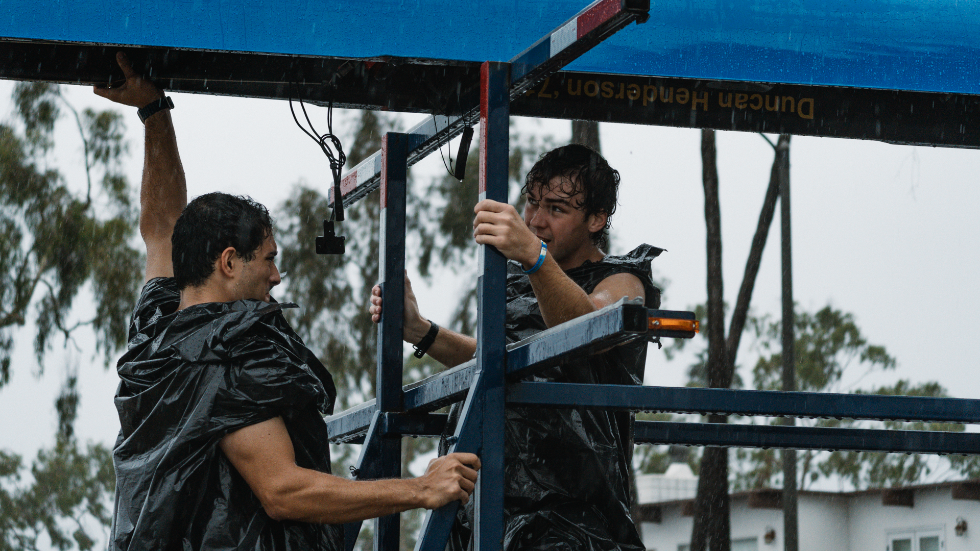 fashionable men lifting in the rain