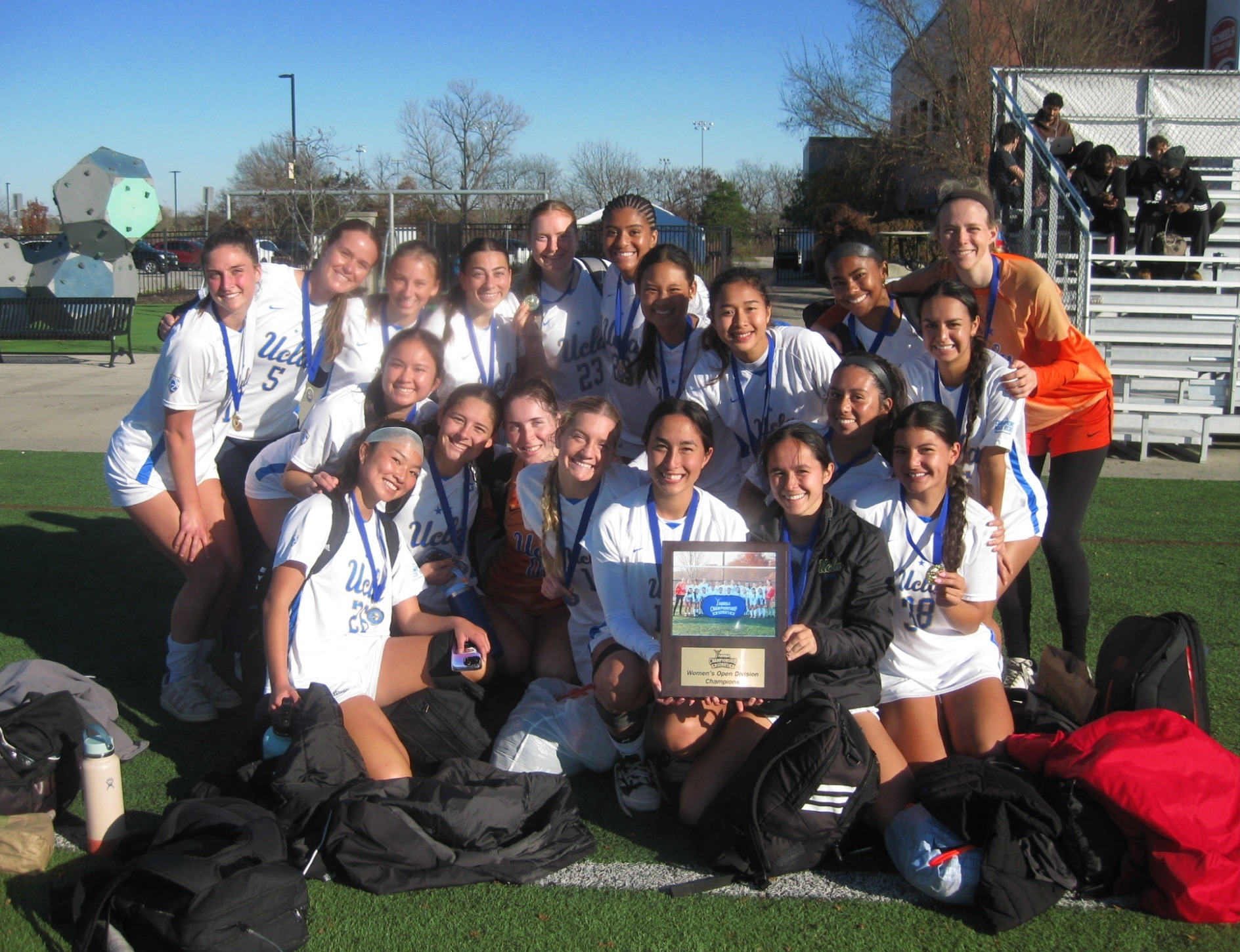 UCLA Women's Club Soccer team with their plaque and medals
