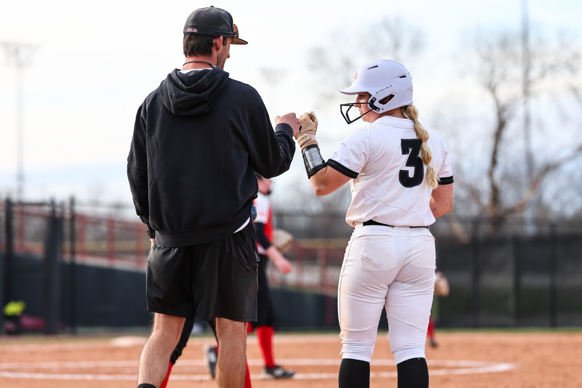 Jeremy Eilert and Aly Hageman at first base of softball game 