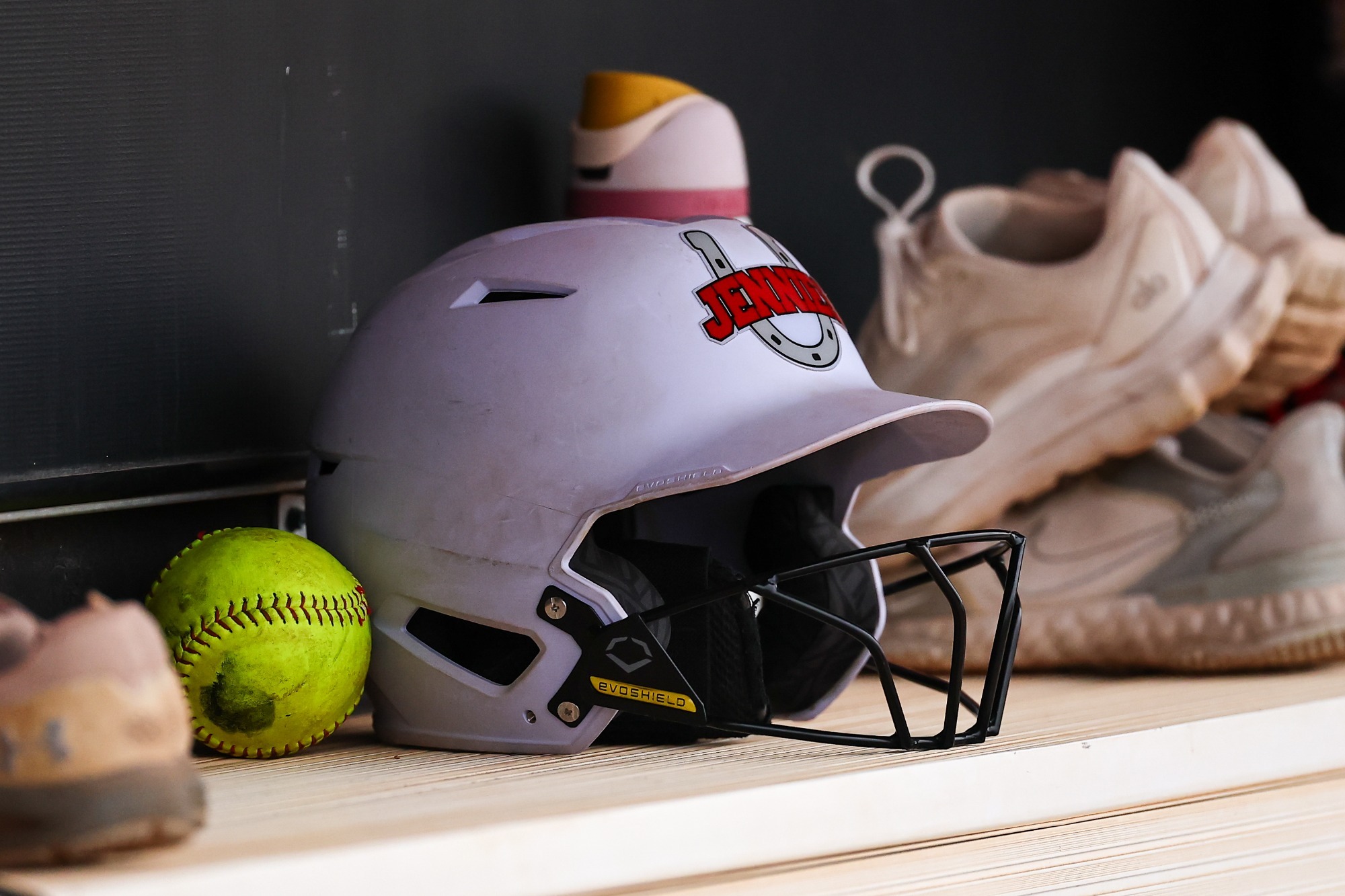 White Jens Softball Helmet in Dugout