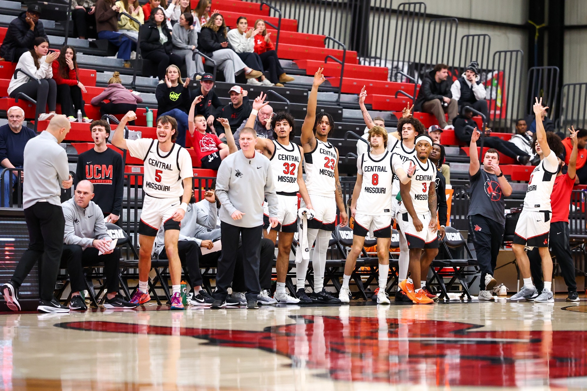Mules basketball bench celebrates a made 3 vs Fort Hays State
