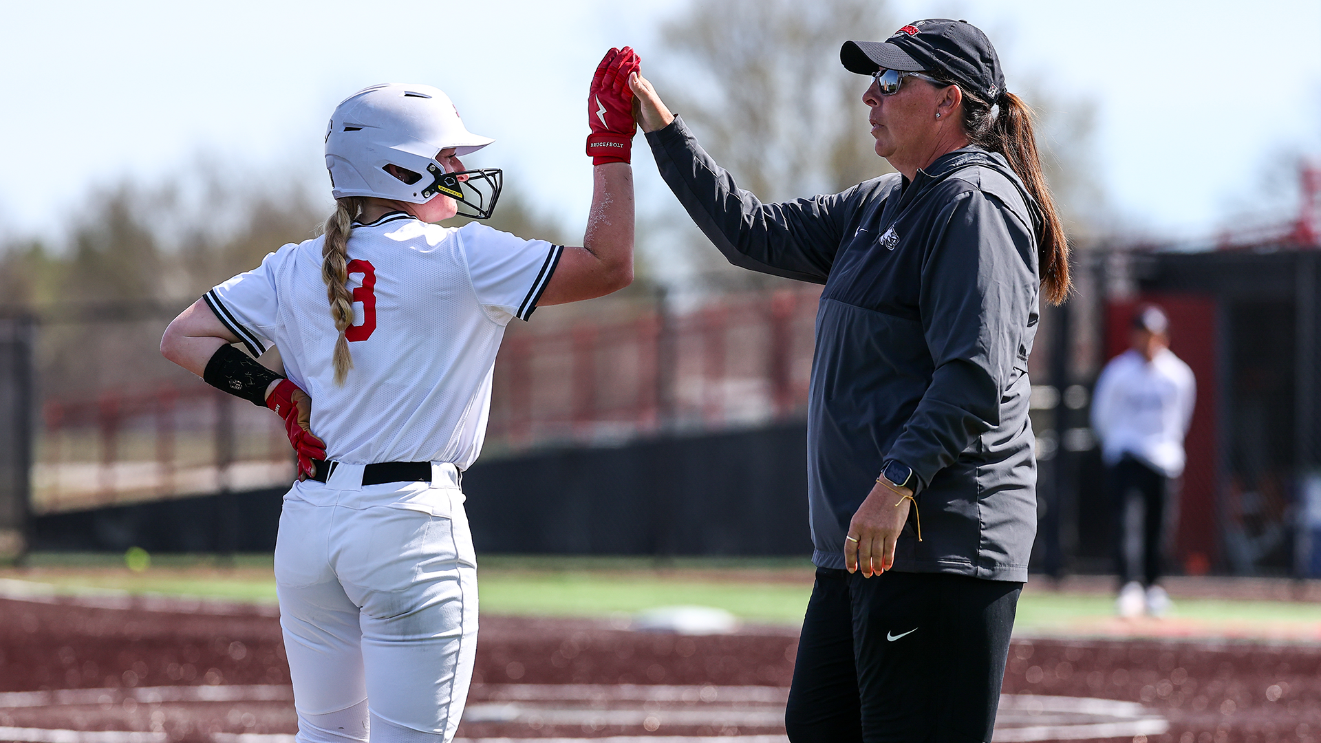 Aly Hageman and Susan Anderson high five vs Fort Hays State