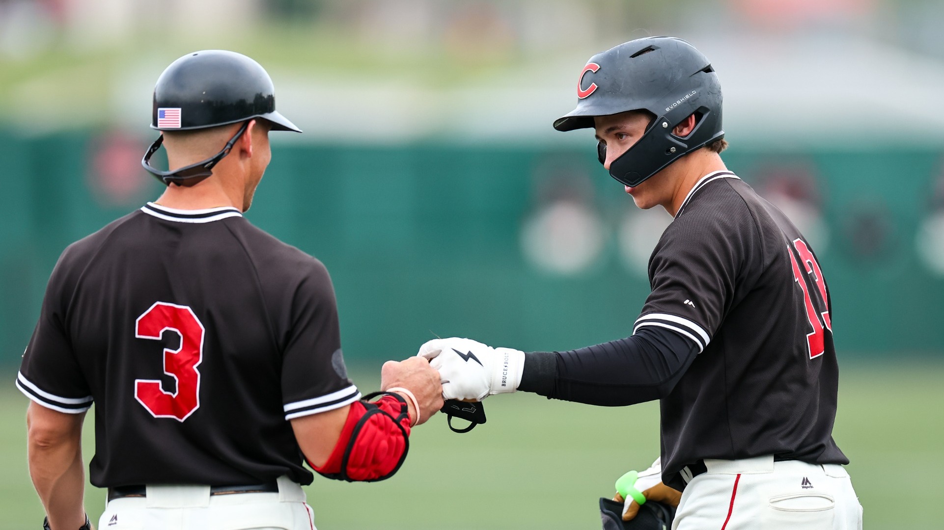 Assistant Coach Alex Backhaus and infielder Grant Hollister (13) vs. Northwest Missouri State
