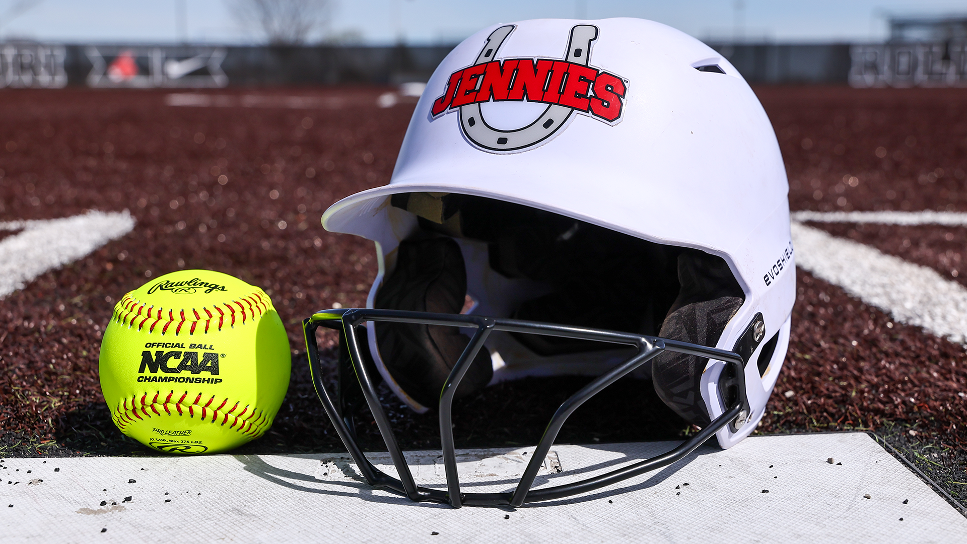 Jennies Softball Helmet & Ball at Home Plate