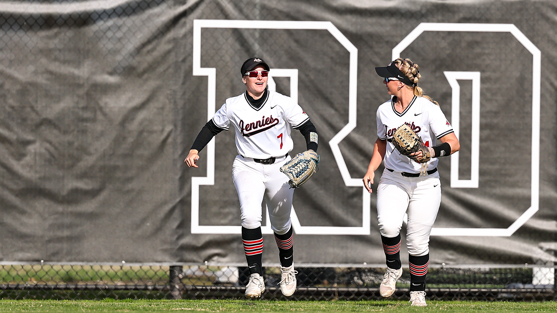 Kyrsten Moran & Emma McCall running in outfield