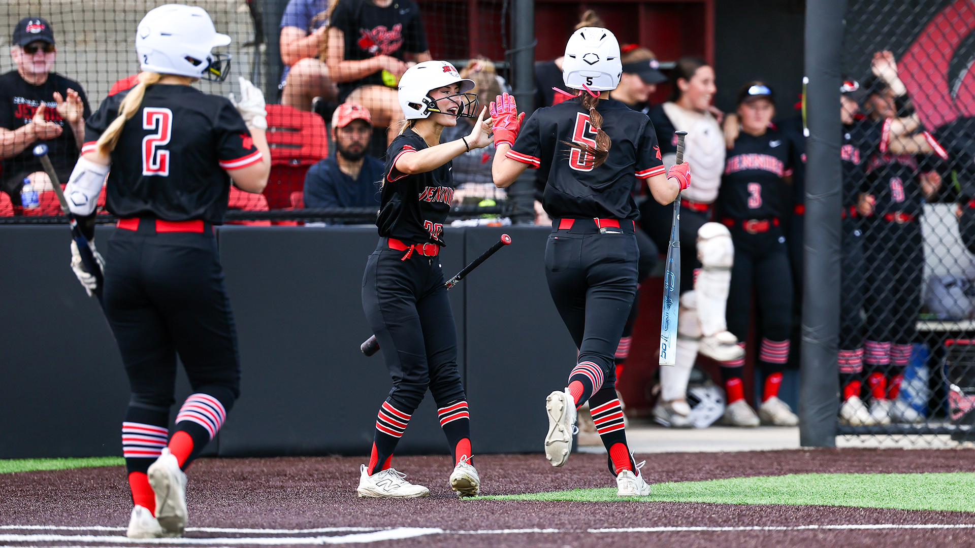 Malia Bucksath high five with Taylor Kvale against UNK