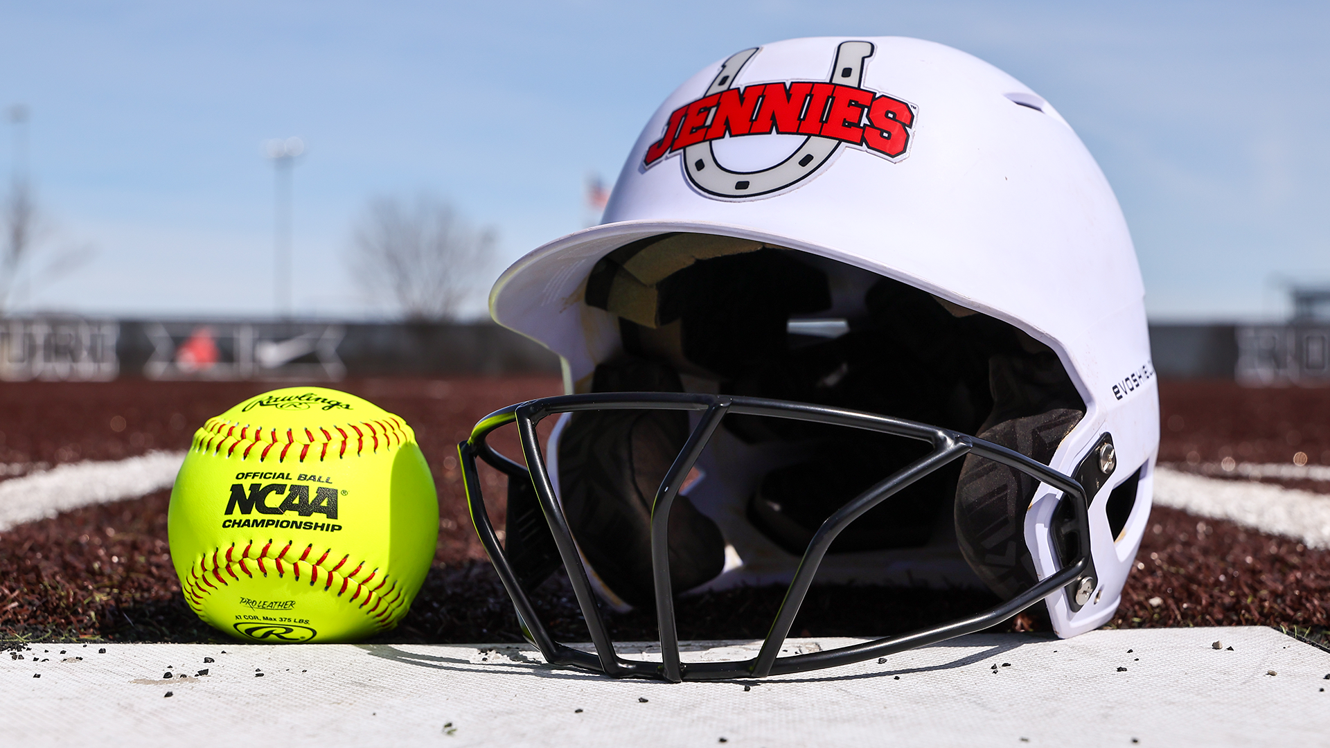 Jens batting helmet with ball on the plate with turf