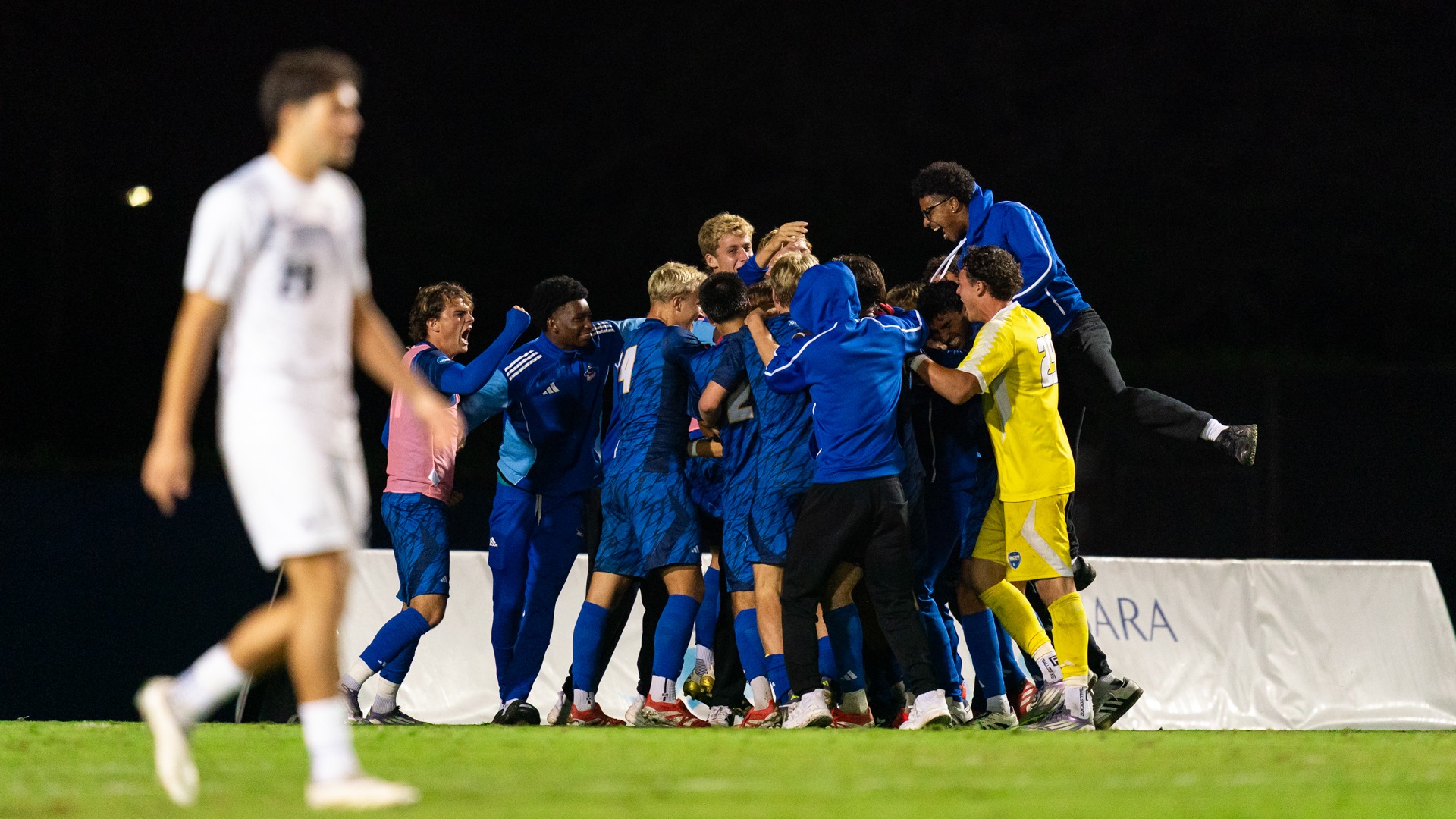 Teammates surround Dominick Phanco in celebration of his goal in The Big West Semifinal
