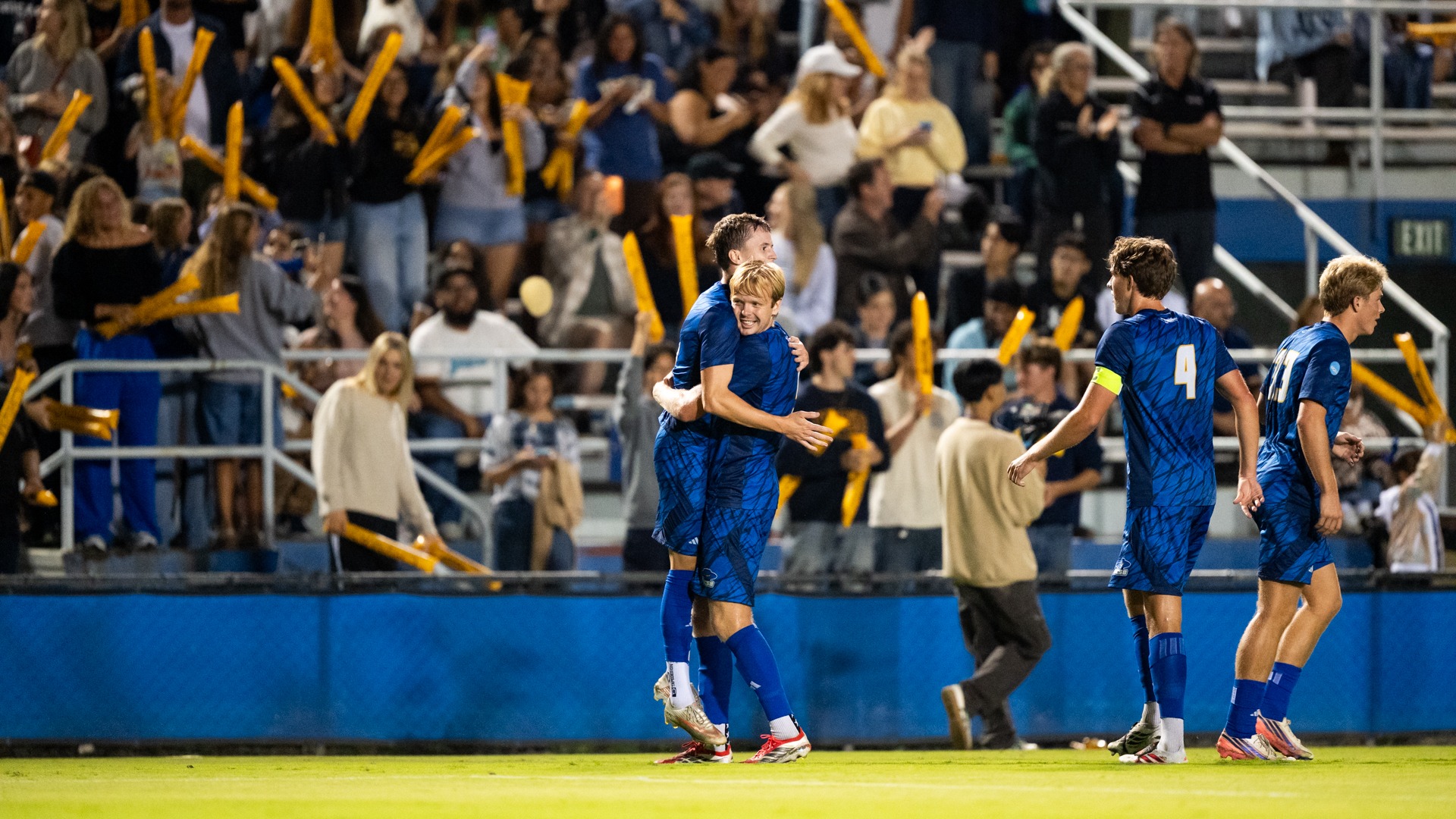 Viggo Gustavsson lifts Steinar Bjornsson off the ground in a celebratory hug. To the right, Calle Mollerberg makes his way to join in the celebration